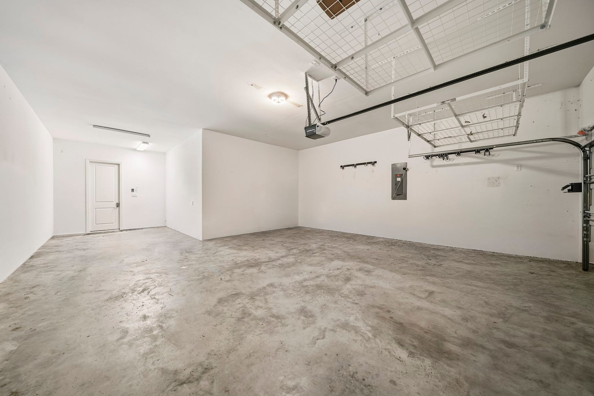 3 car tandem garage, with opener, ceiling storage, (There is a workbench to stay and peg board to stay). There is also a 240 plug if you need to add electric car plug in. Picture was virtually altered to delete items currently in garage so you can see space.