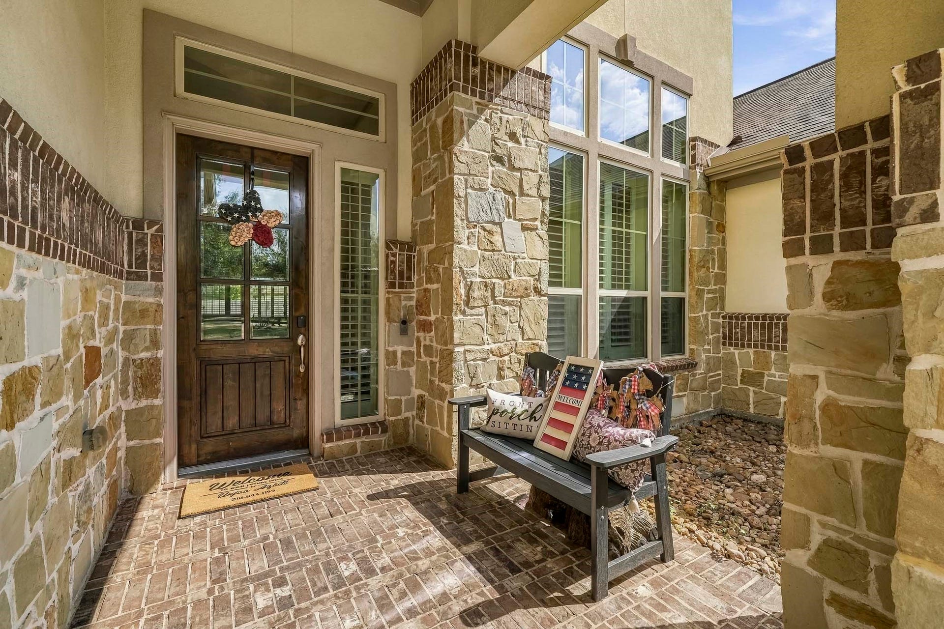 Inviting entry. 8ft leaded glass front door. Stucco, Stone and Brick elevation.