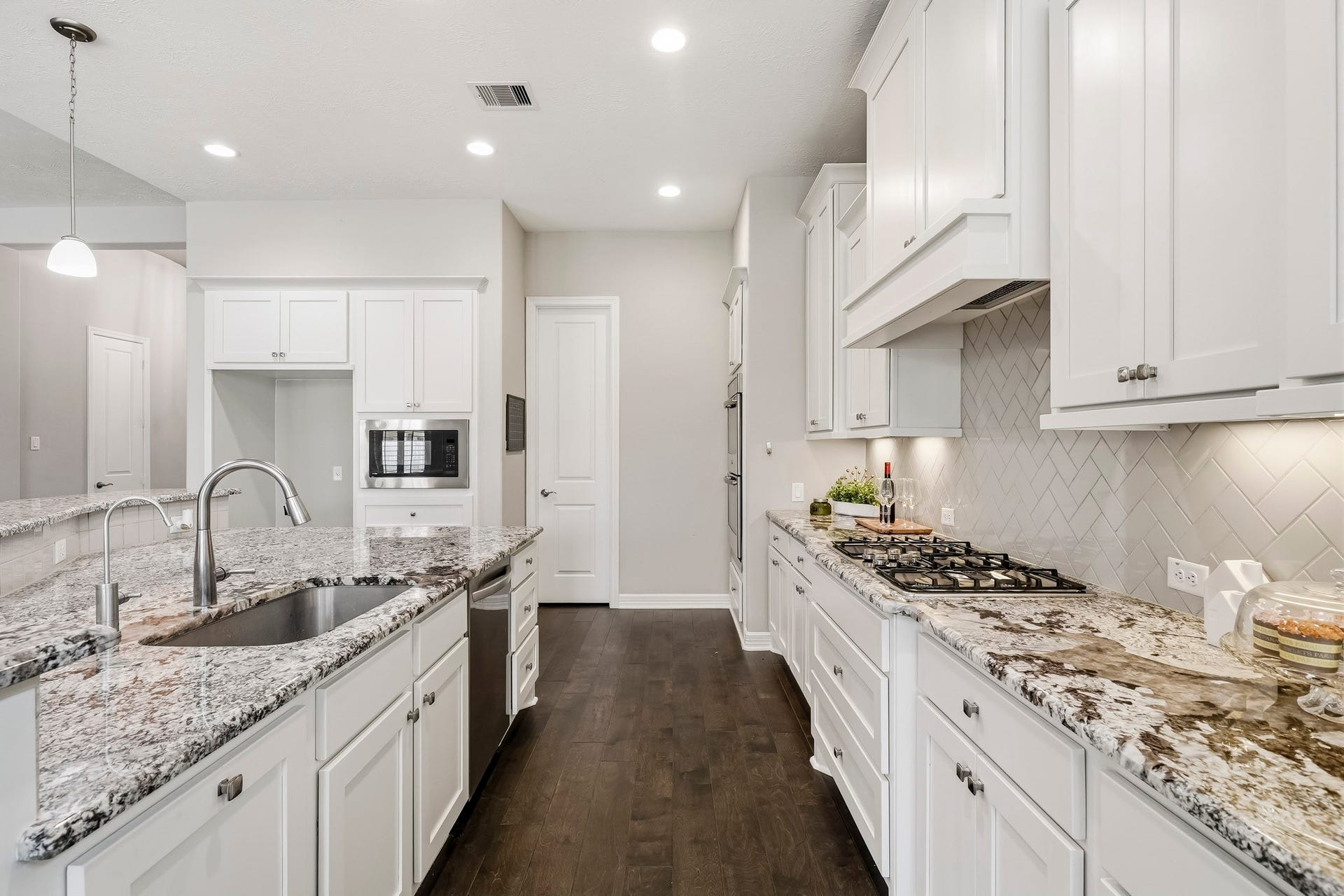 double ovens, built-in microwave, J Kraft custom cabinetry, undercounter lighting and an amazing walk-in pantry with electric power for small appliances and automatic light switch.