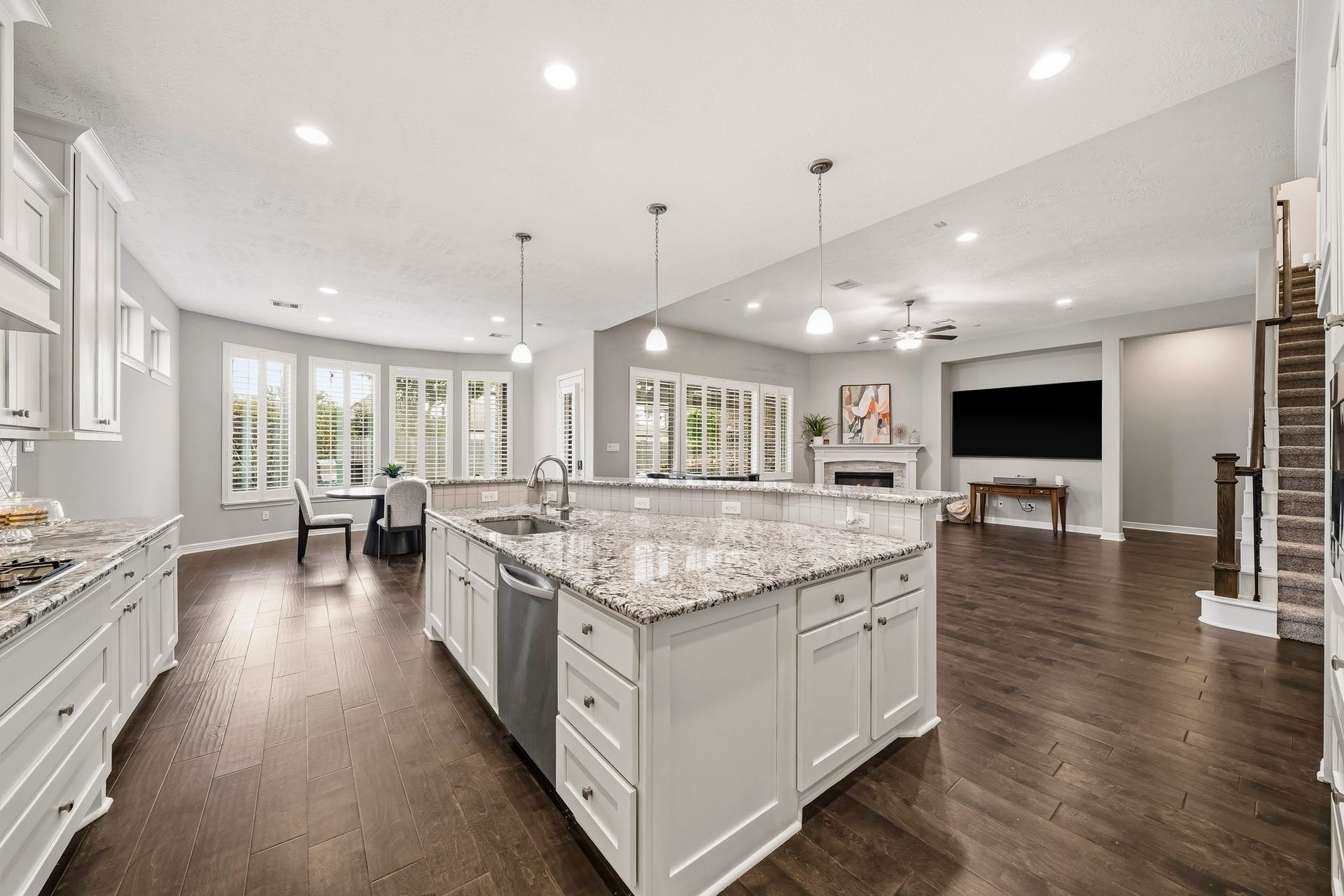 Kitchen is open to family room. High/low kitchen island with upgraded granite counters, undermount sink, pendant lighting...