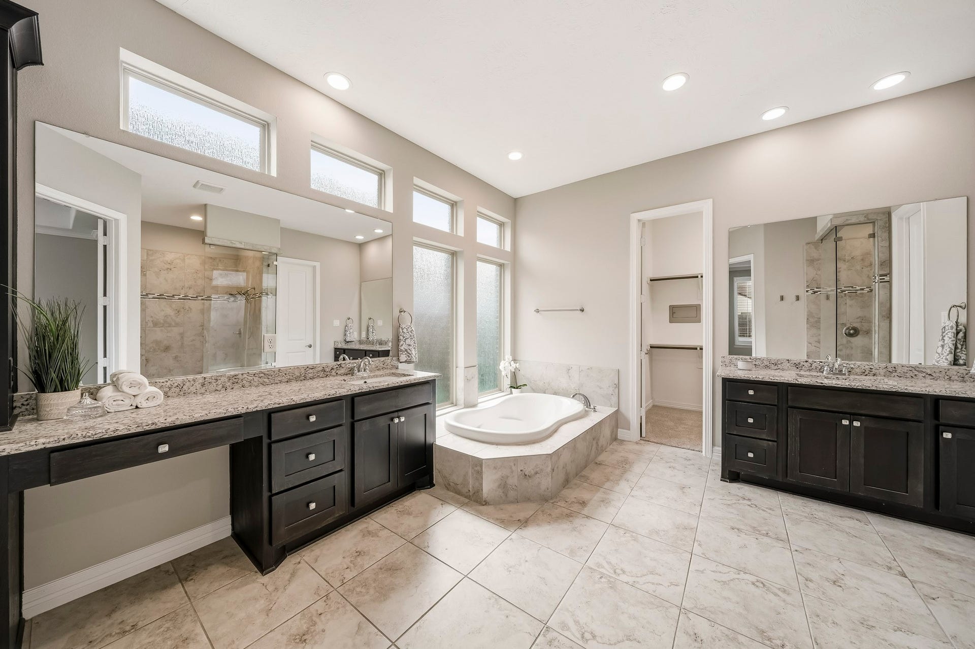 Large primary bath has 2 separate sinks, vanity, soaking tub, 2 headed oversized shower...