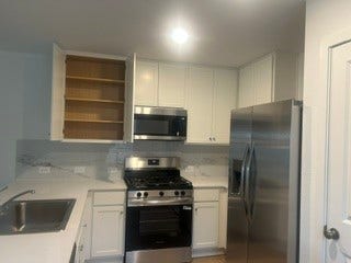 Modern kitchen featuring stainless steel appliances, sleek cabinetry, and ample counter space for all your culinary needs.