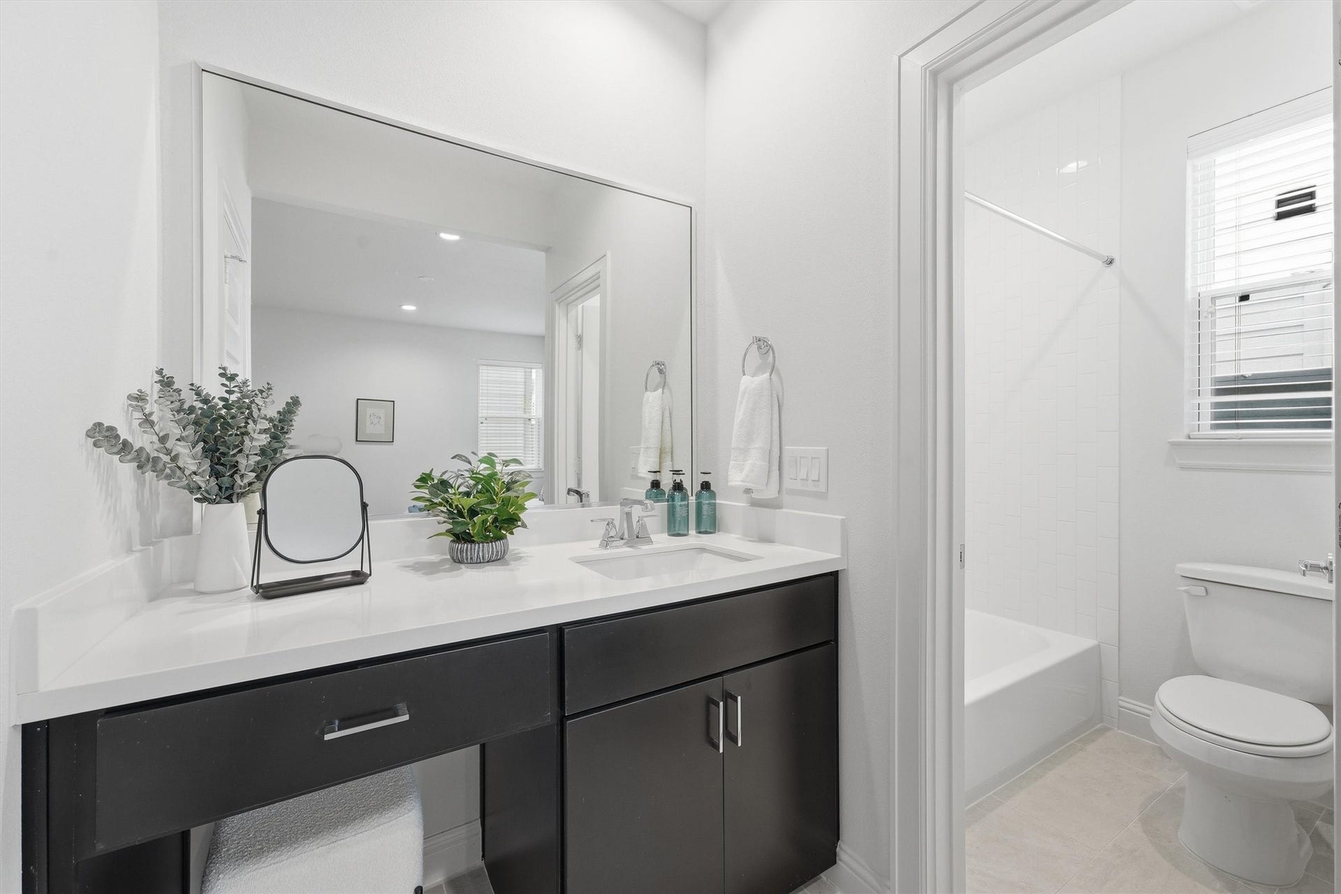 1804 Elysian Street, Houston, TX 77026 Sleek and inviting, this guest bathroom boasts a modern vanity, ample lighting, and a pristine shower area, perfectly blending style and comfort for your visitors.