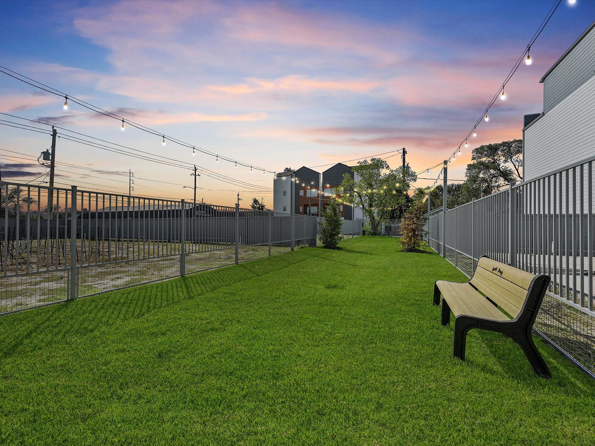1804 Elysian Street, Houston, TX 77026 Experience delightful evenings with your furry friend in this charming dog park, complete with lush greenery and ambient string lights.