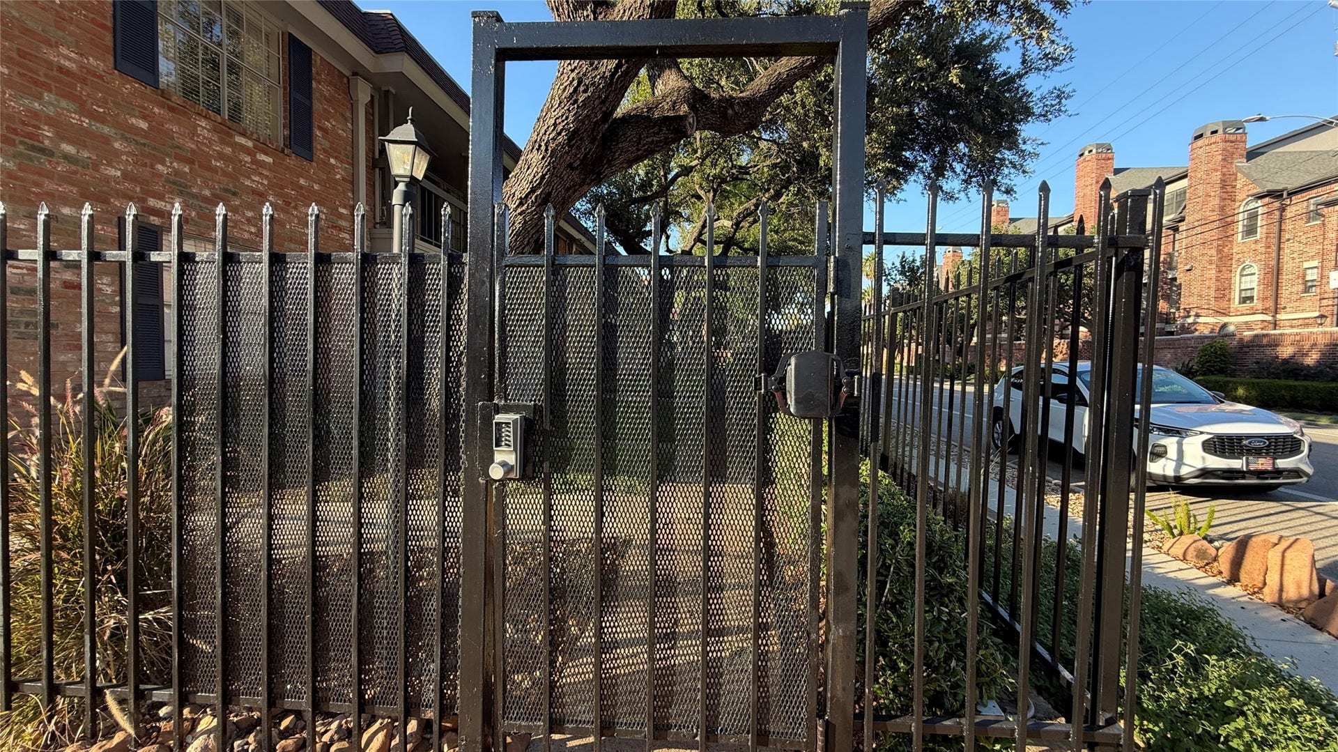 2250 Bering Drive, #40, Houston, TX 77057 Controlled-access pedestrian gate offers convenient entry to the landscaped condominium community.