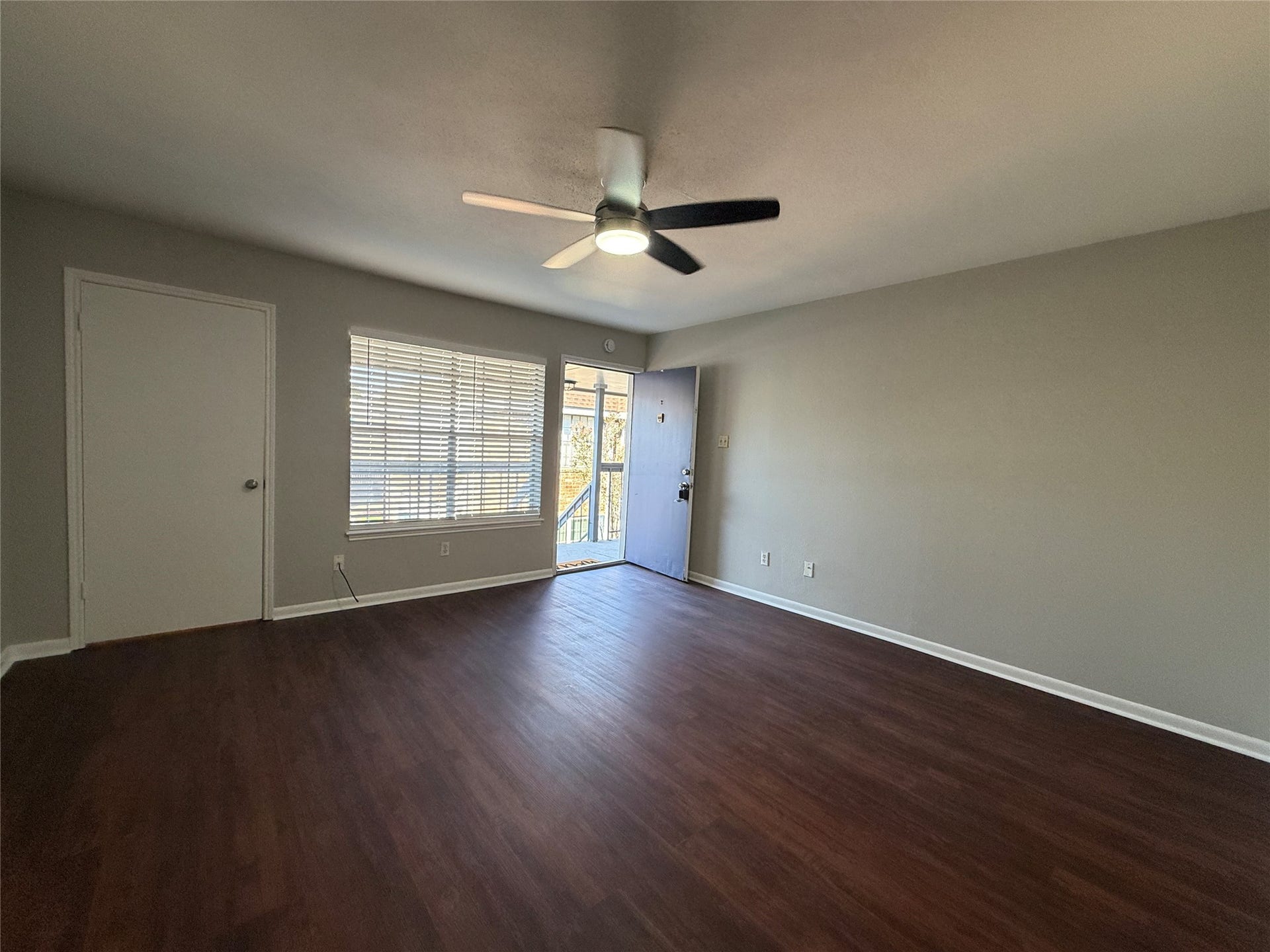 2250 Bering Drive, #40, Houston, TX 77057 Inviting living area featuring vinyl plank flooring, neutral paint tones, and natural light.