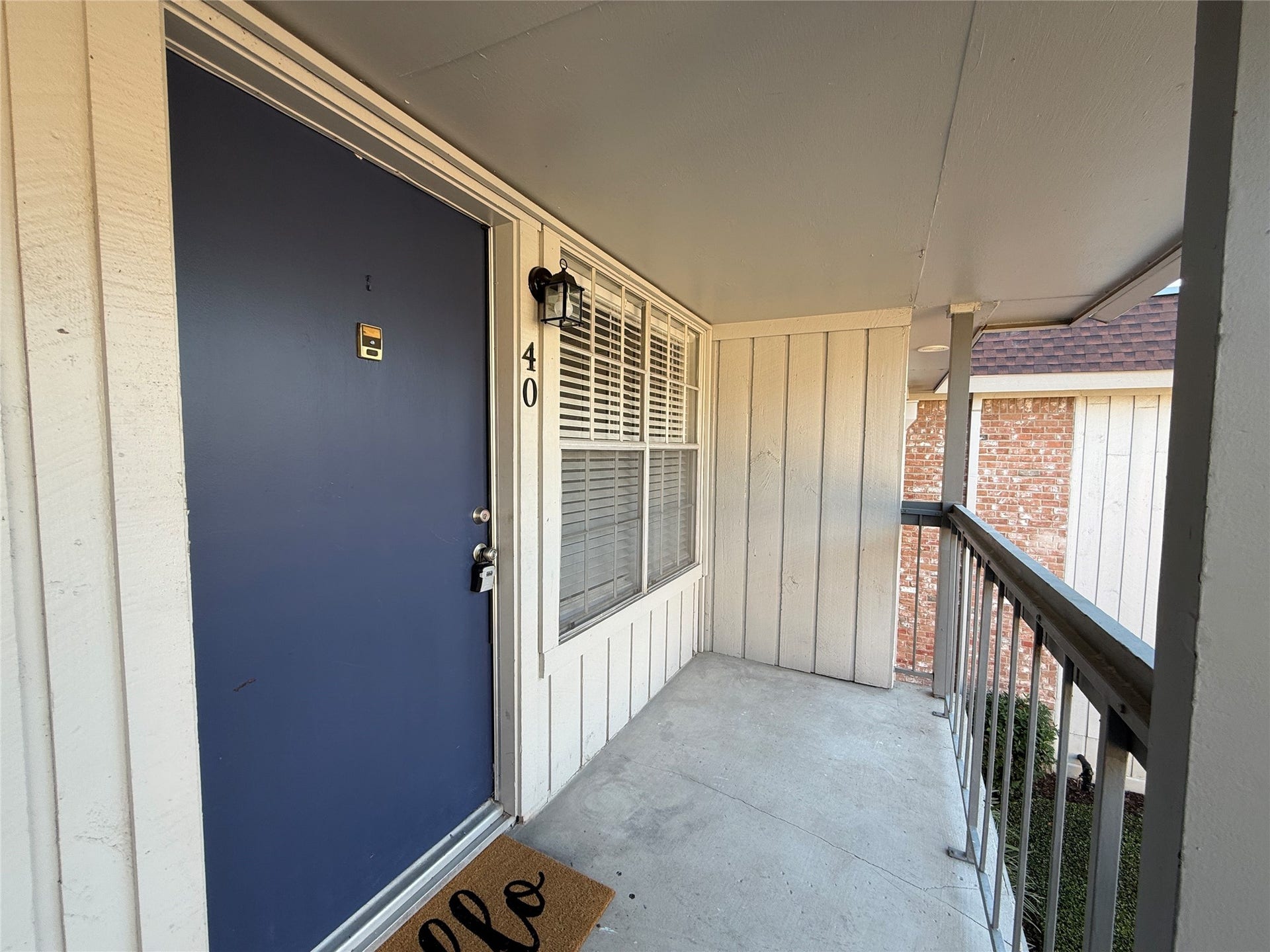 2250 Bering Drive, #40, Houston, TX 77057 Covered second-floor balcony overlooking the landscaped courtyard, offering a welcoming outdoor space.
