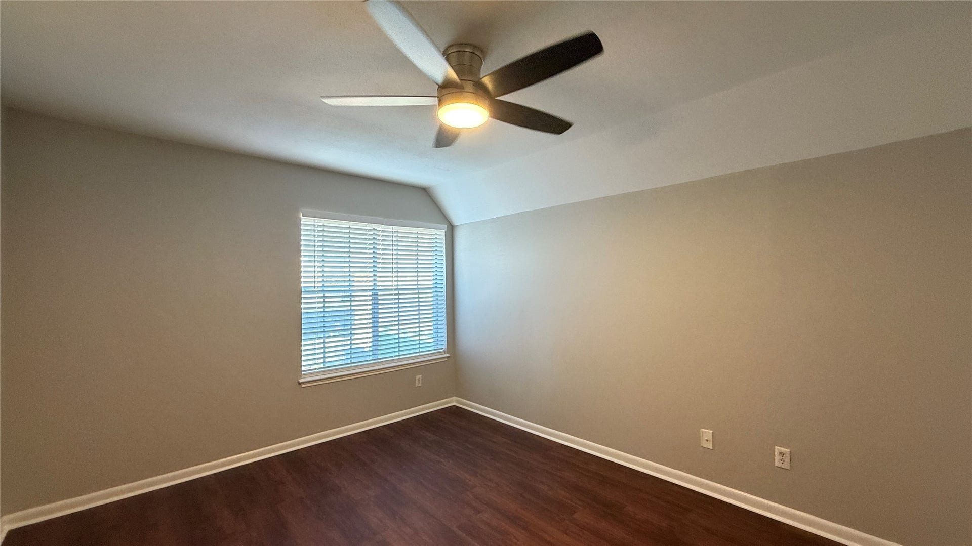 2250 Bering Drive, #40, Houston, TX 77057 Comfortable bedroom featuring warm vinyl plank flooring, neutral tones, ceiling fan, and natural light.