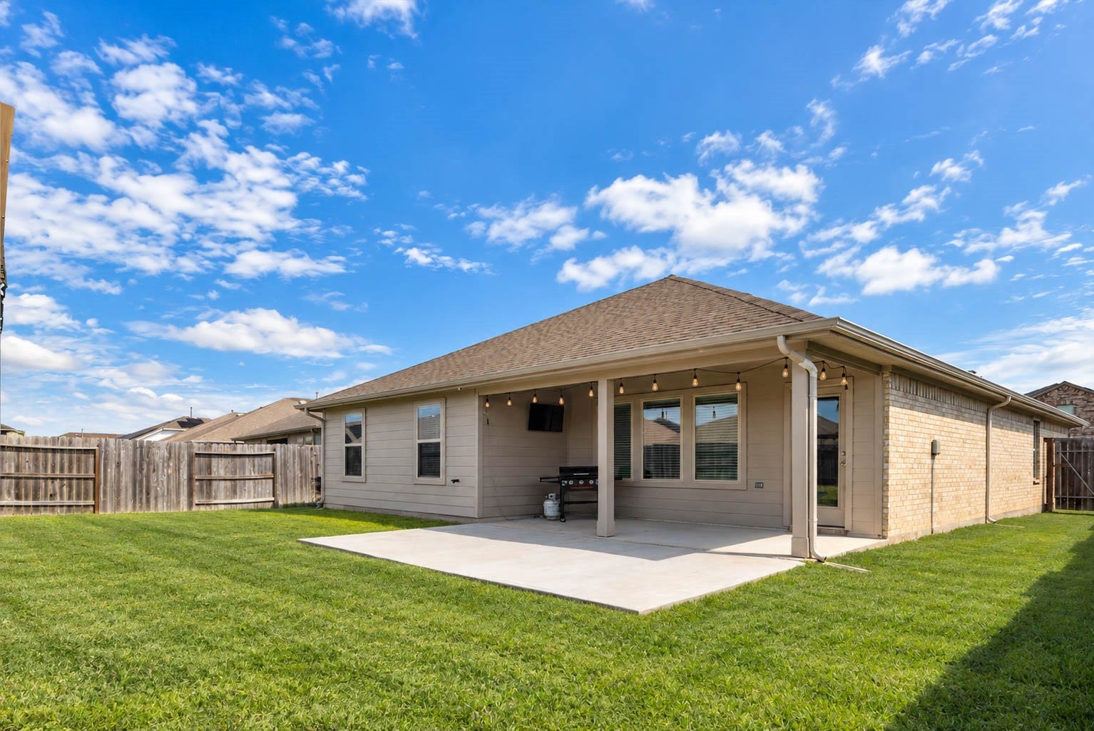 15303 Dinnet Berm Drive, Humble, TX 77346 Step outside to the perfect spot to relax and unwind. A covered patio with an extended concrete pad offers extra room for seating and entertaining!