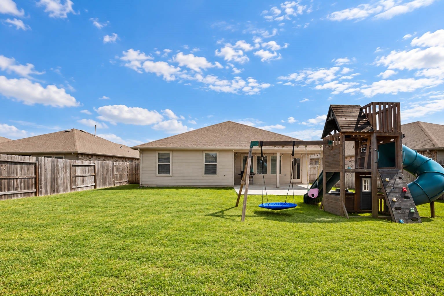 15303 Dinnet Berm Drive, Humble, TX 77346 The fenced backyard with an automatic sprinkler system also provides plenty of green space for play, pets, or gardening.