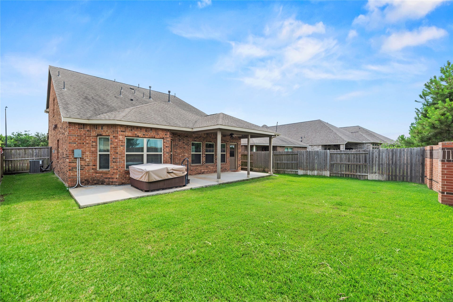 6418 Shadowbrook Hollow Trail, Katy, TX 77493 Another perspective of the backyard shows off the sprawling lawn and wrap-around green space, offering an open layout that easily accommodates future playground sets or gardening projects.