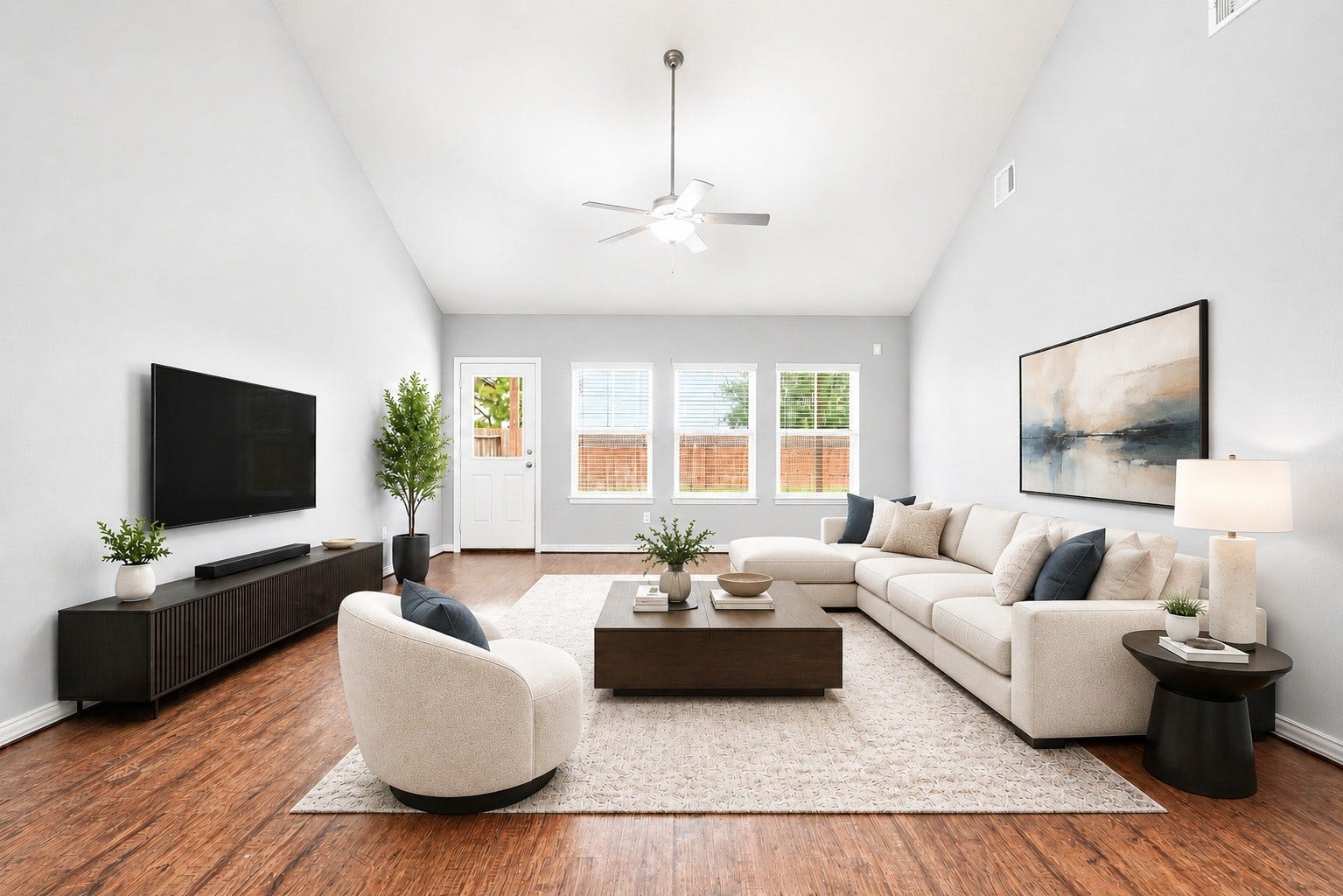 6418 Shadowbrook Hollow Trail, Katy, TX 77493 The living room features dramatic high ceilings, central ceiling fan cooling, a wall of windows framing backyard views, and a half-lite door providing quick access to the backyard. Virtually staged.