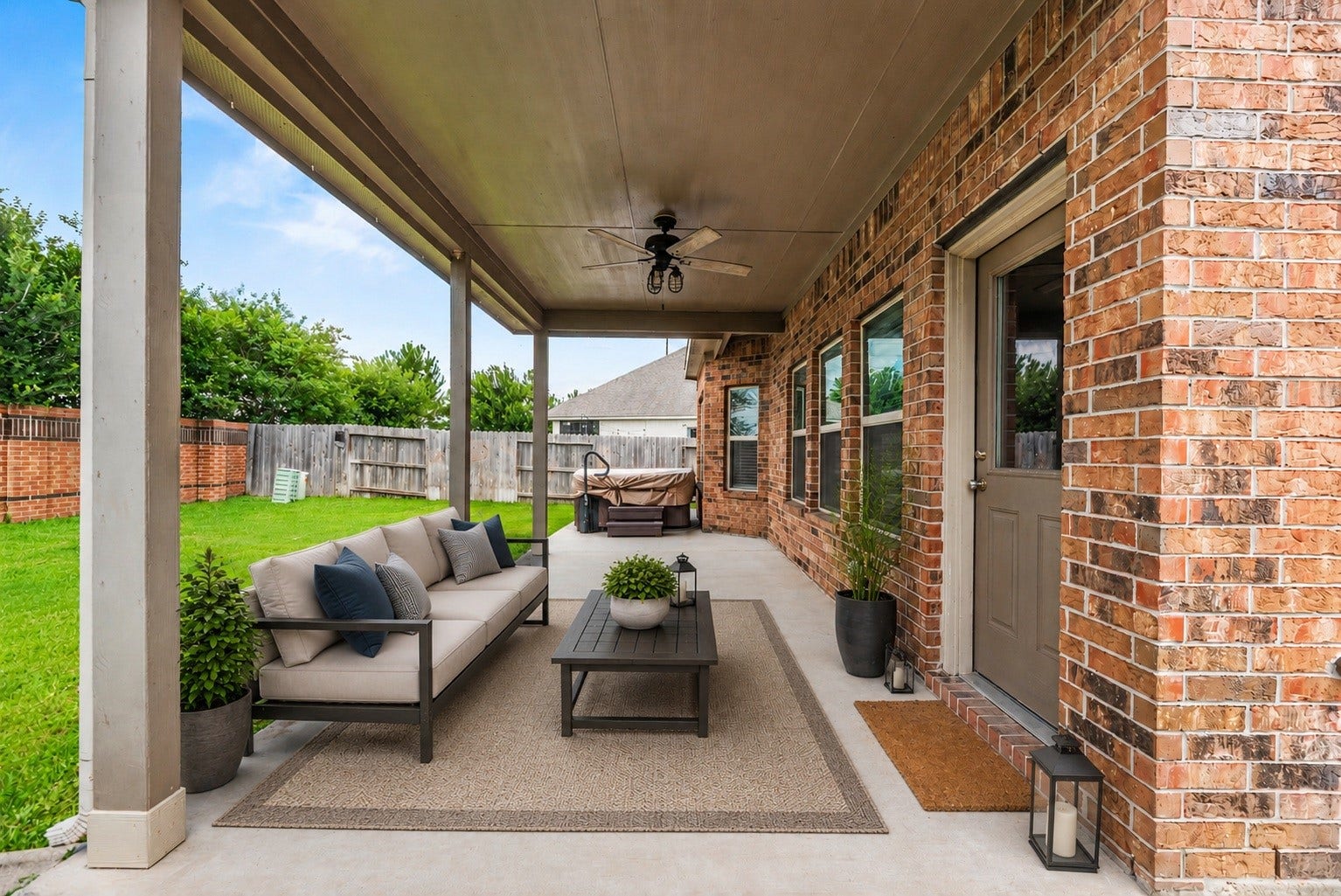 6418 Shadowbrook Hollow Trail, Katy, TX 77493 The outdoor entertaining area features a deep concrete covered patio complete with an outdoor ceiling fan, providing a cool, shaded environment for open-air dining and relaxation. Virtually staged.