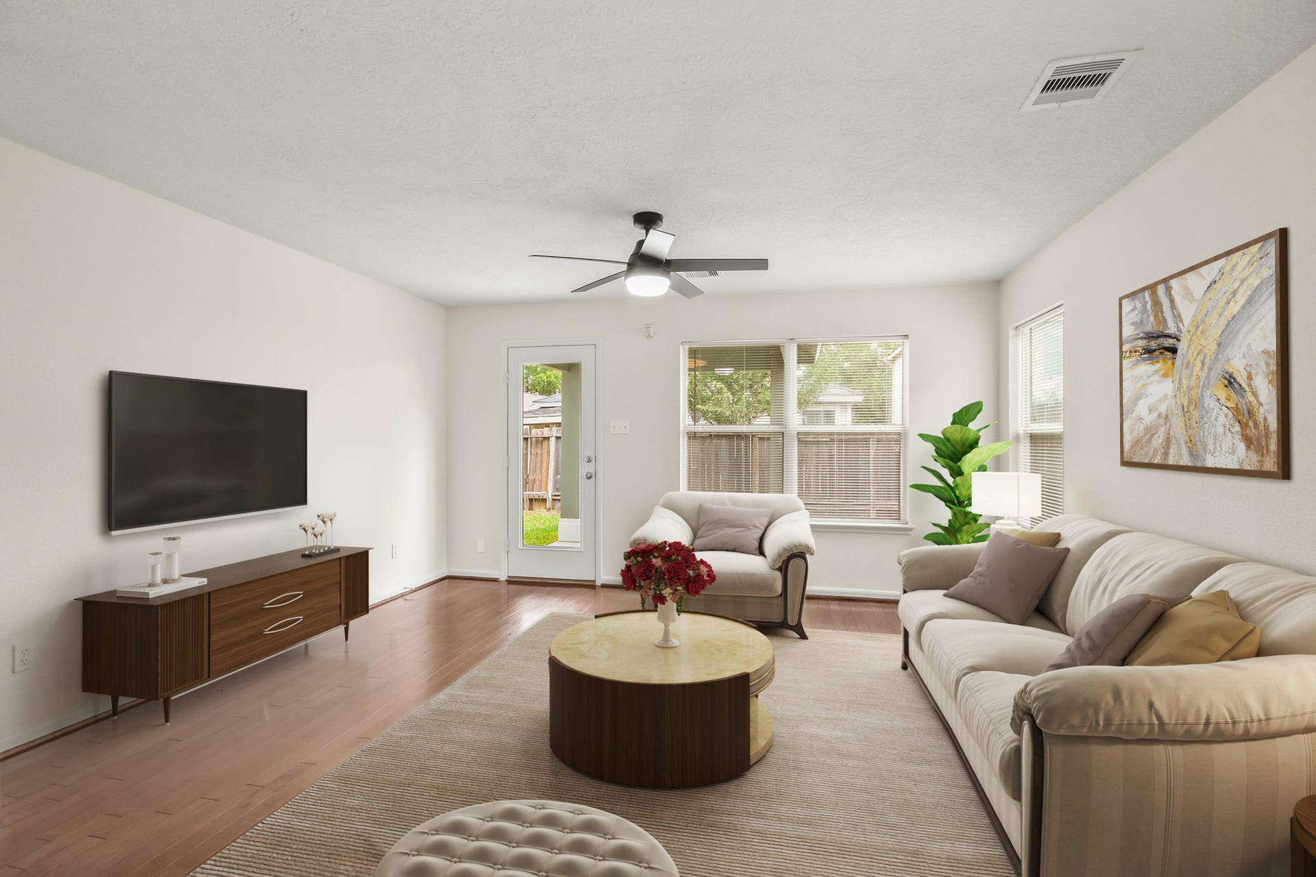 255 Silky Leaf Drive, Houston, TX 77073 Virtually Staged: This cozy living room features beautiful wood floors, a ceiling fan, and beautiful views of the backyard are provided by large windows.
