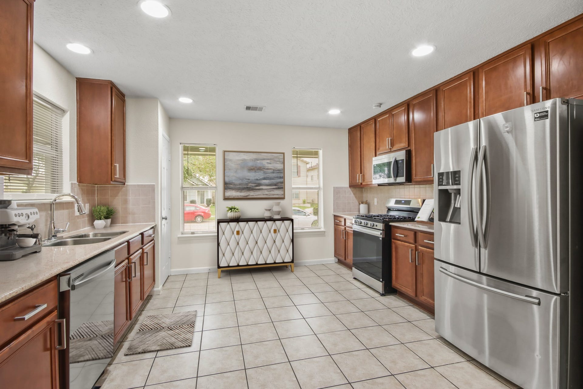 255 Silky Leaf Drive, Houston, TX 77073 Virtually Staged: Beautiful kitchen with granite countertops, open space, steel stainless appliances, recessed lighting, and plenty of wooden cabinetry for storage. It includes a pantry as well.