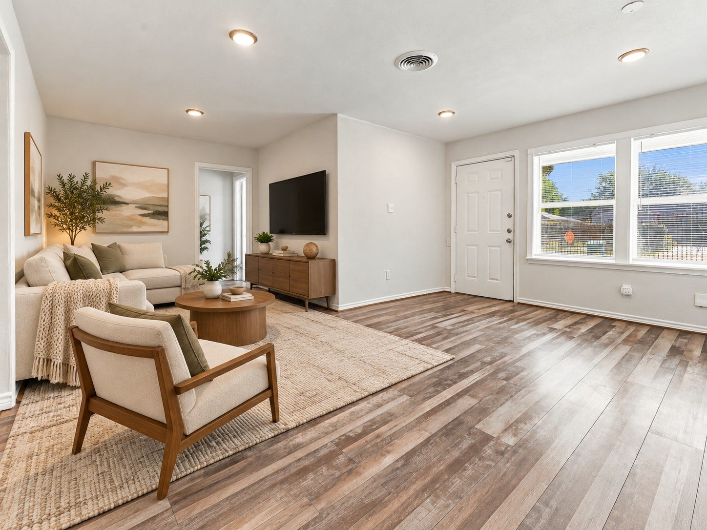 What a lovely living space! High ceilings, recessed lighting, beautiful wood-look laminate flooring, and large windows create a bright and welcoming atmosphere. The spacious layout flows effortlessly into the adjoining dining area, making this a wonderful place to gather with family and friends. *Virtually Staged*