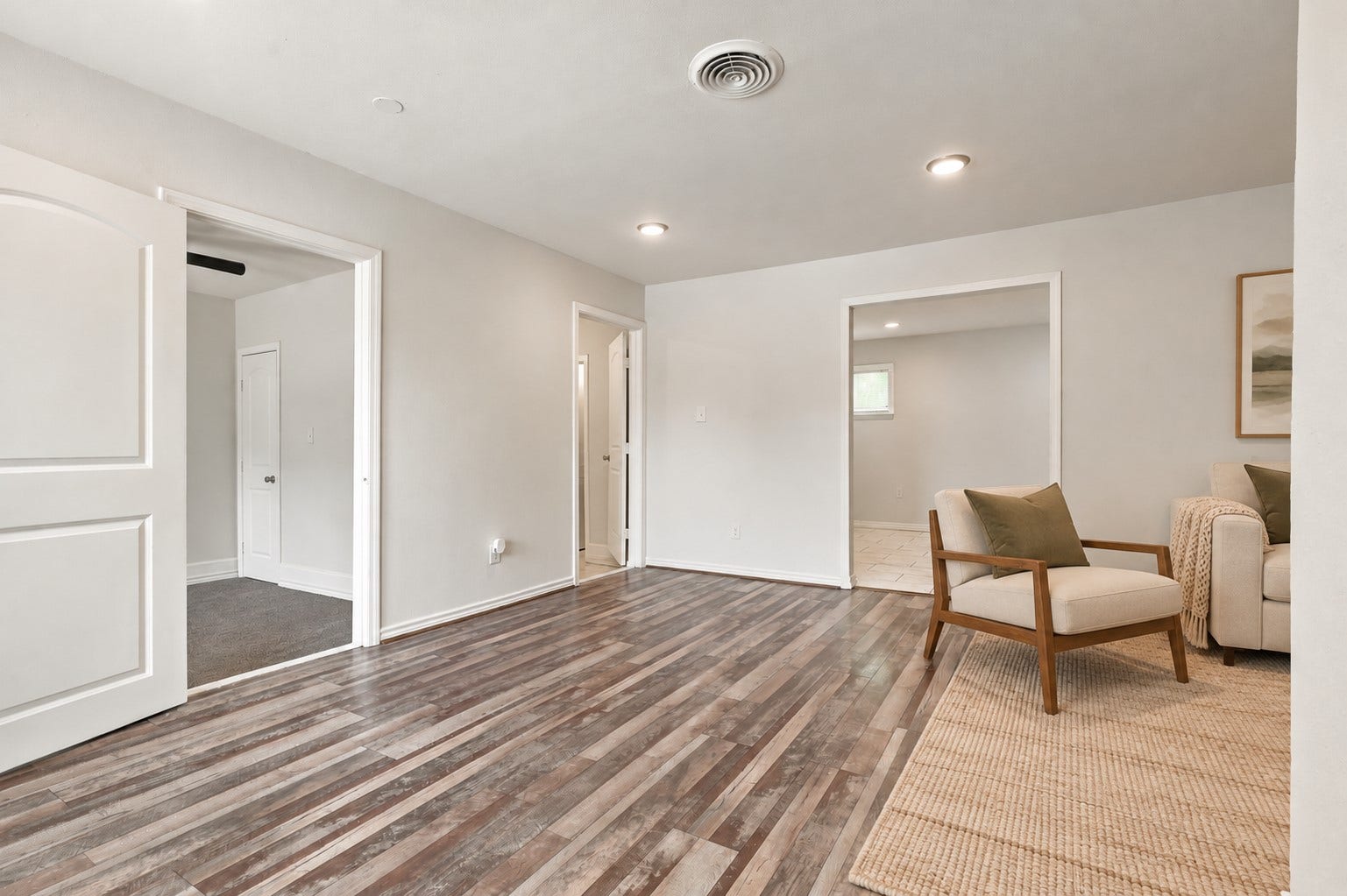 Step inside and imagine the possibilities! This spacious living area features beautiful wood-look laminate flooring, high ceilings, recessed lighting, and a neutral color palette that makes decorating a breeze. With plenty of room to arrange your favorite furnishings, this inviting space is ready for your personal touch!