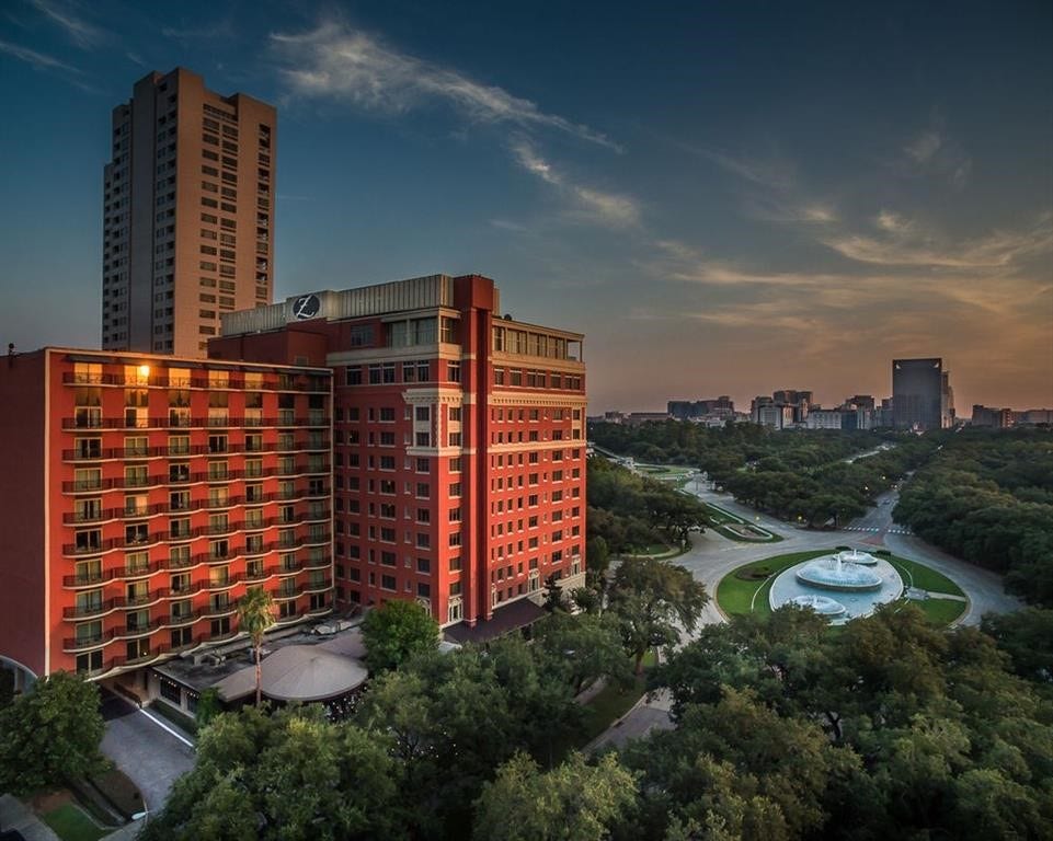 Enjoy a glimpse of Houston's vibrant city life! This beautiful view features impressive high-rise buildings, lush green surroundings, and attractive landscaped grounds, highlighting the blend of urban convenience and green spaces that make exploring the Houston area so enjoyable.