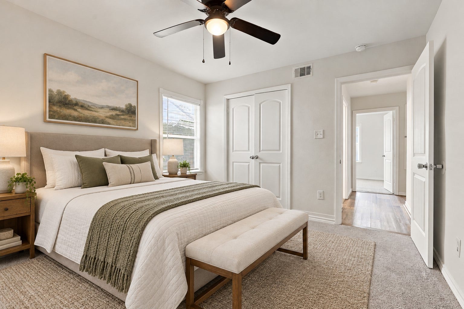 Come see this inviting primary retreat! The spacious layout, soft carpeting, ceiling fan, and windows bringing in natural light create a relaxing atmosphere. Beautifully staged with warm, neutral furnishings, this lovely bedroom offers the perfect place to rest and recharge. *Virtually Staged*