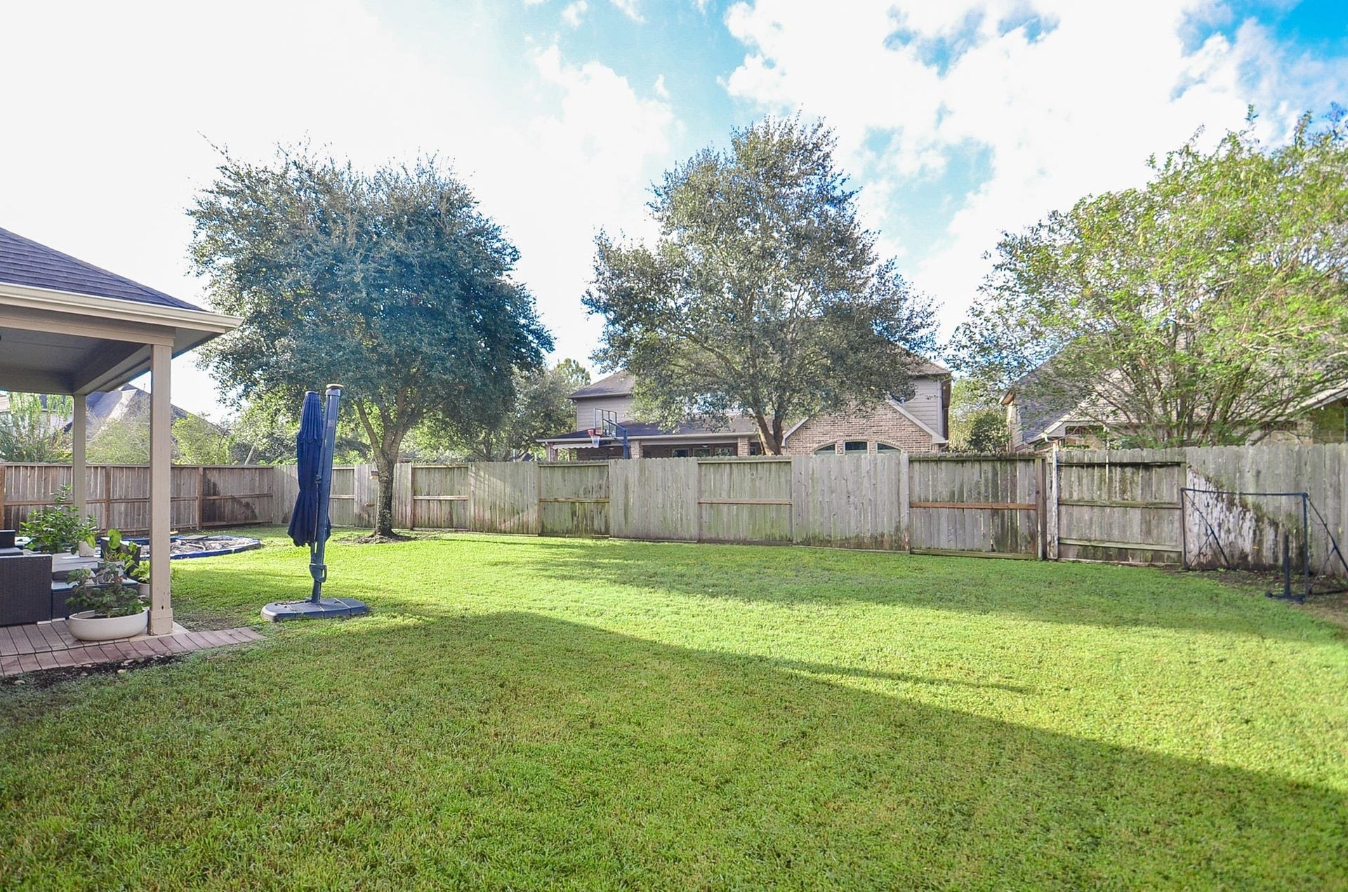 28503 Pleasant Forest Drive, Katy, TX 77494 Expansive backyard with mature trees and plenty of room for outdoor activities.