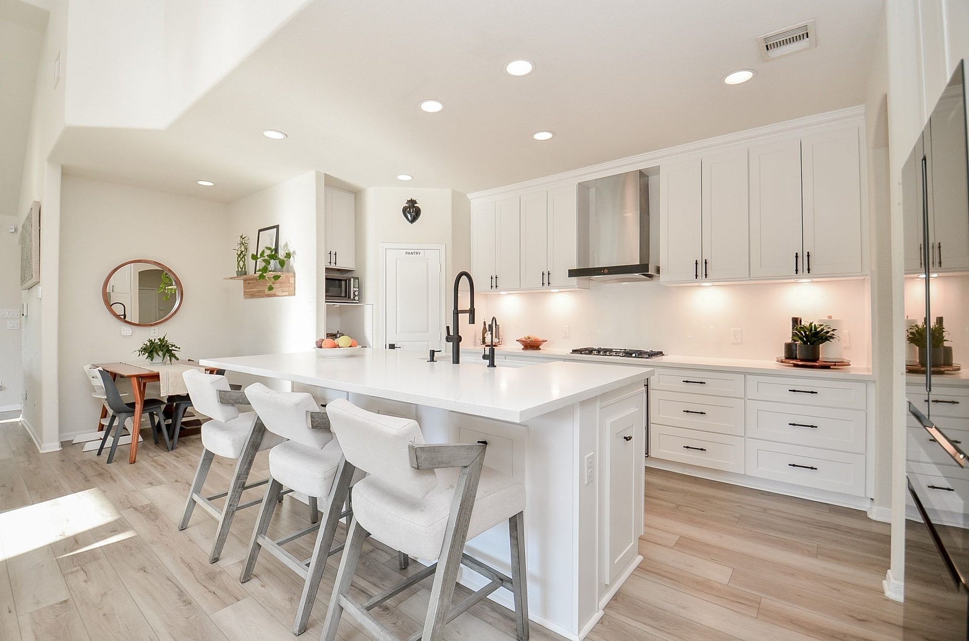 28503 Pleasant Forest Drive, Katy, TX 77494 Stunning renovated kitchen with white cabinetry, oversized island, and sleek finishes.
