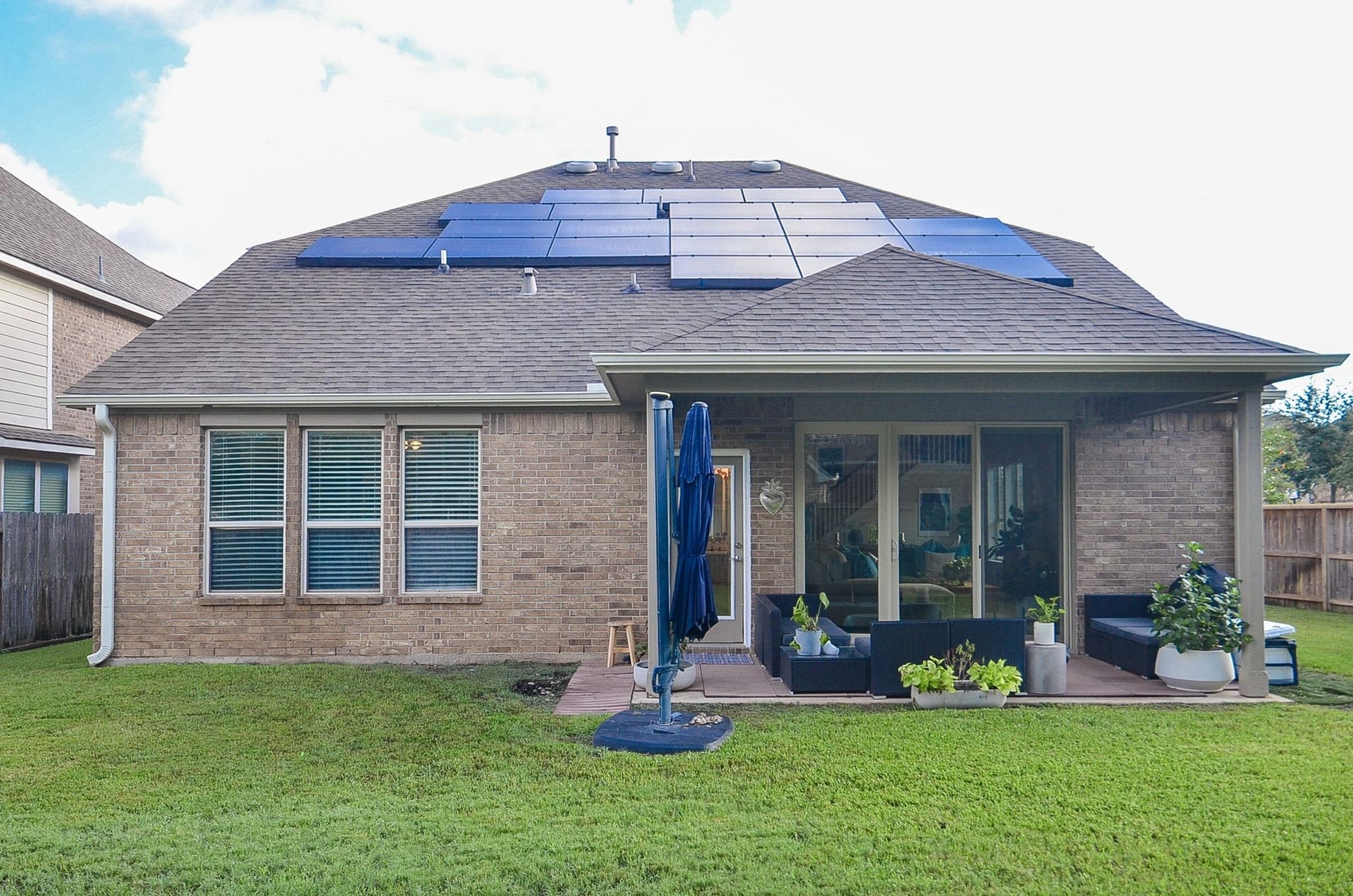 28503 Pleasant Forest Drive, Katy, TX 77494 Covered backyard patio and roof-mounted solar panels enhance outdoor living and energy efficiency.