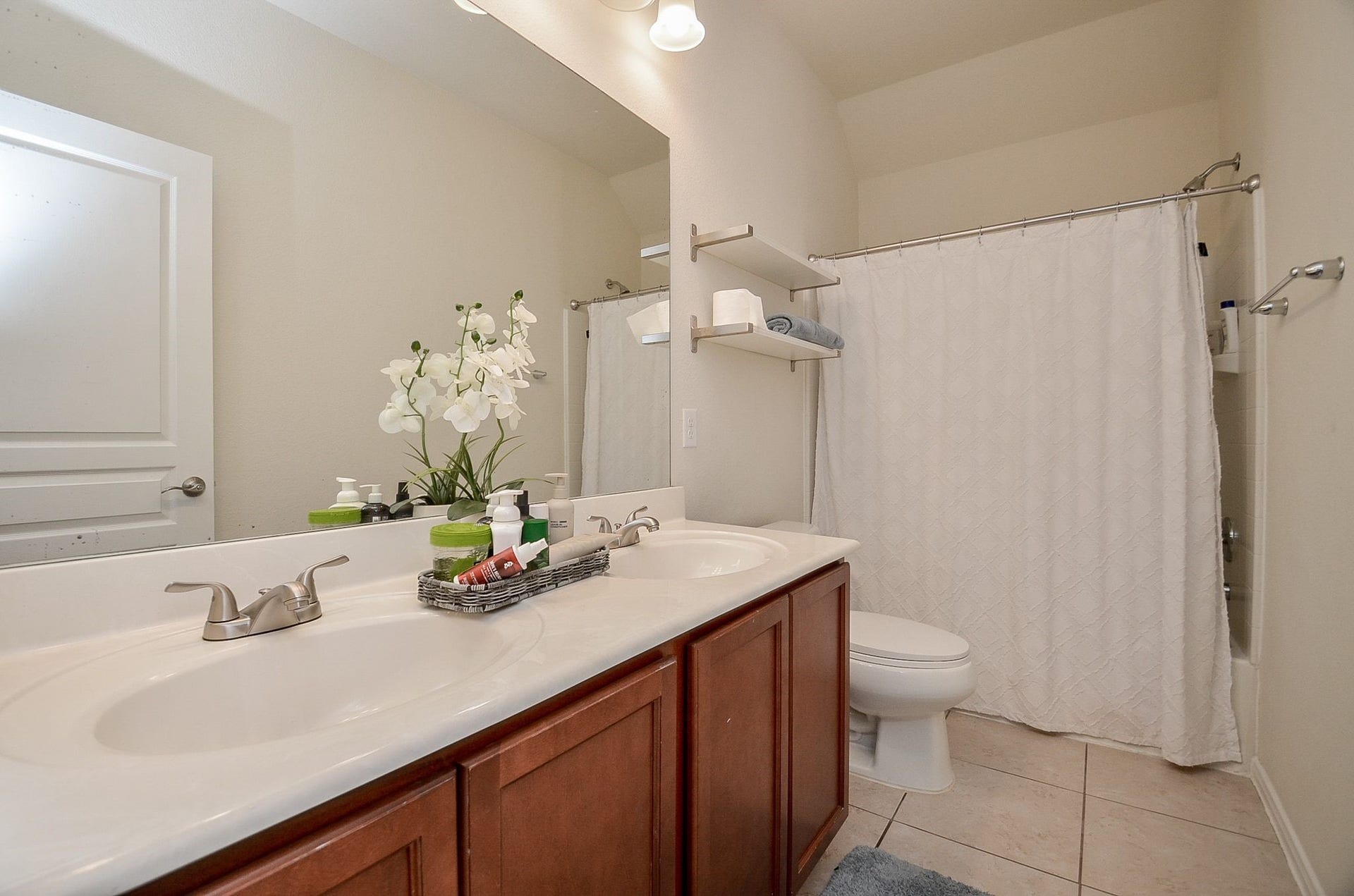 28503 Pleasant Forest Drive, Katy, TX 77494 Upstairs bathroom featuring dual sinks and a tub/shower combination.