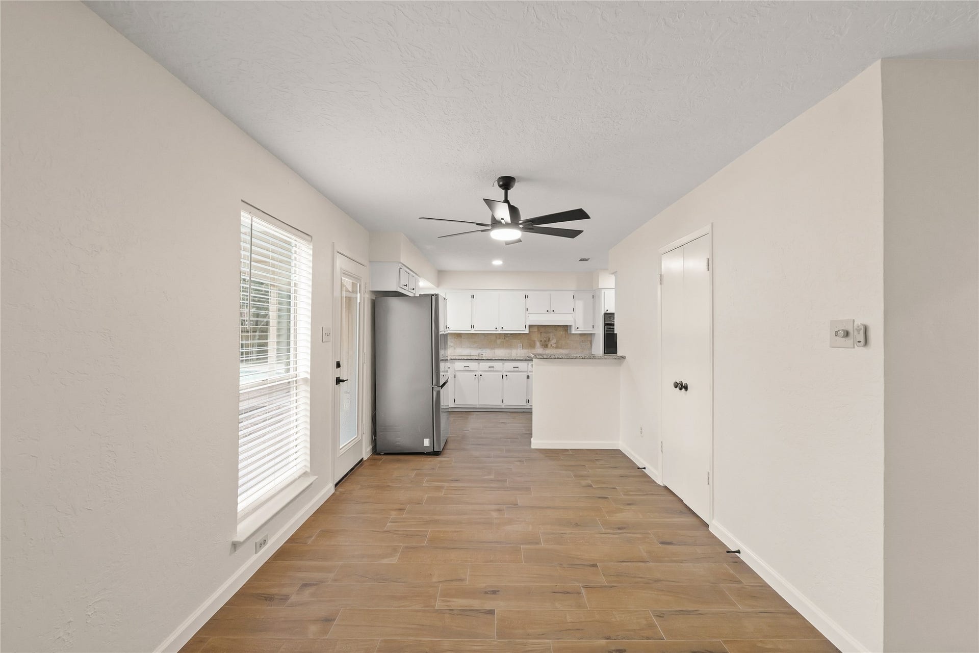 Dining area with view of kitchen and door to backyard