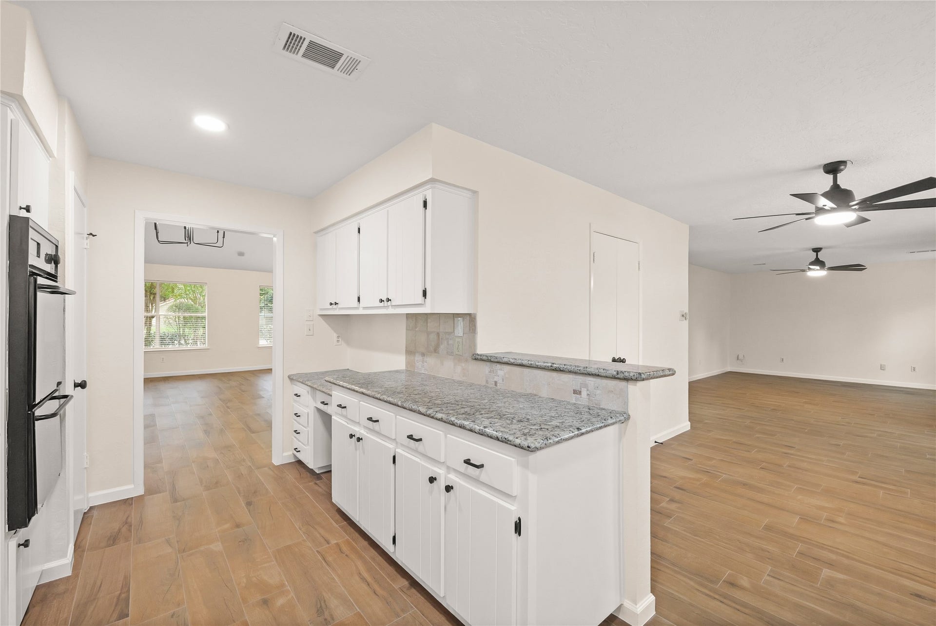 View of kitchen, entrance to formal dining area, breakfast area, and family room