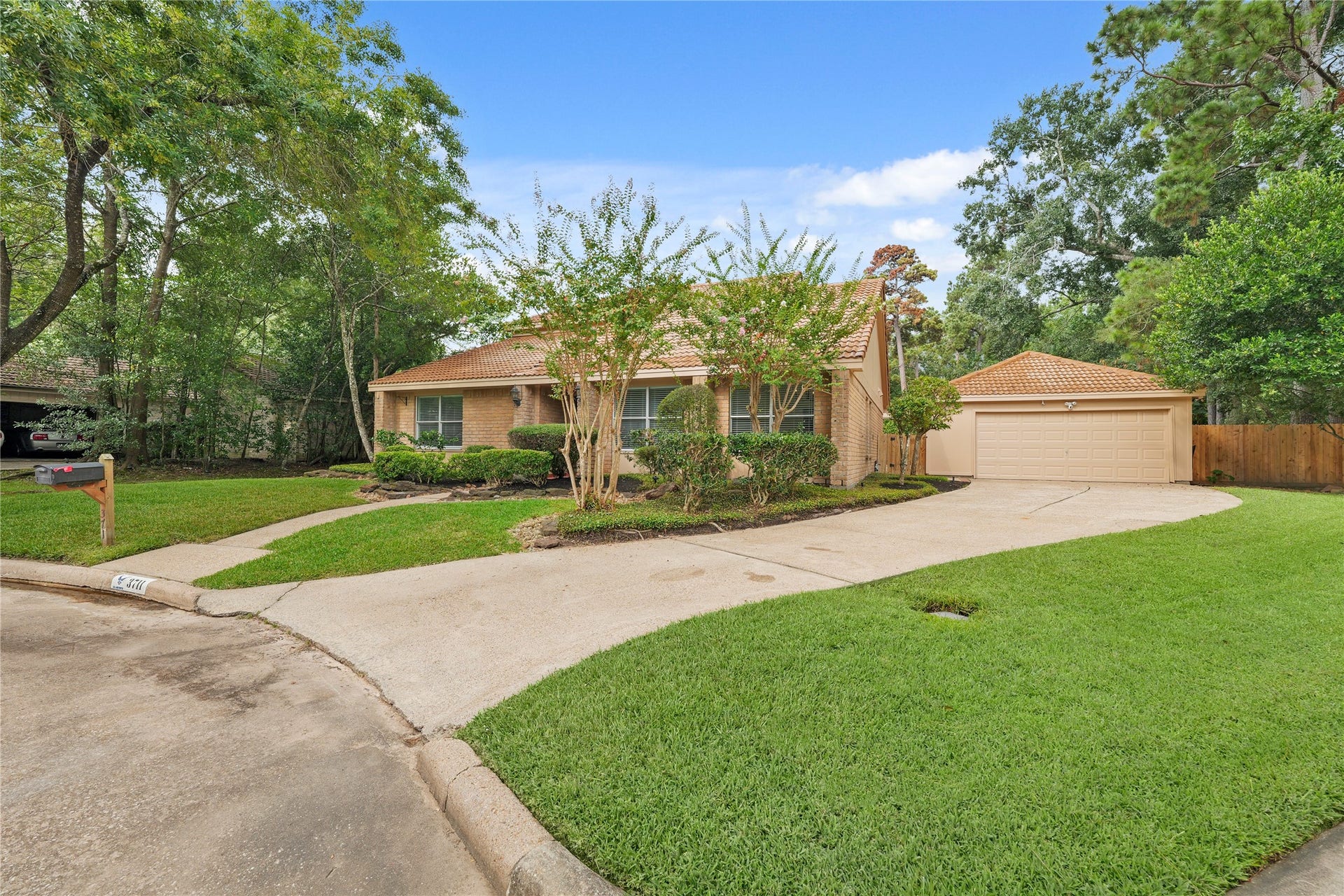 Long driveway leads to spacious detached garage