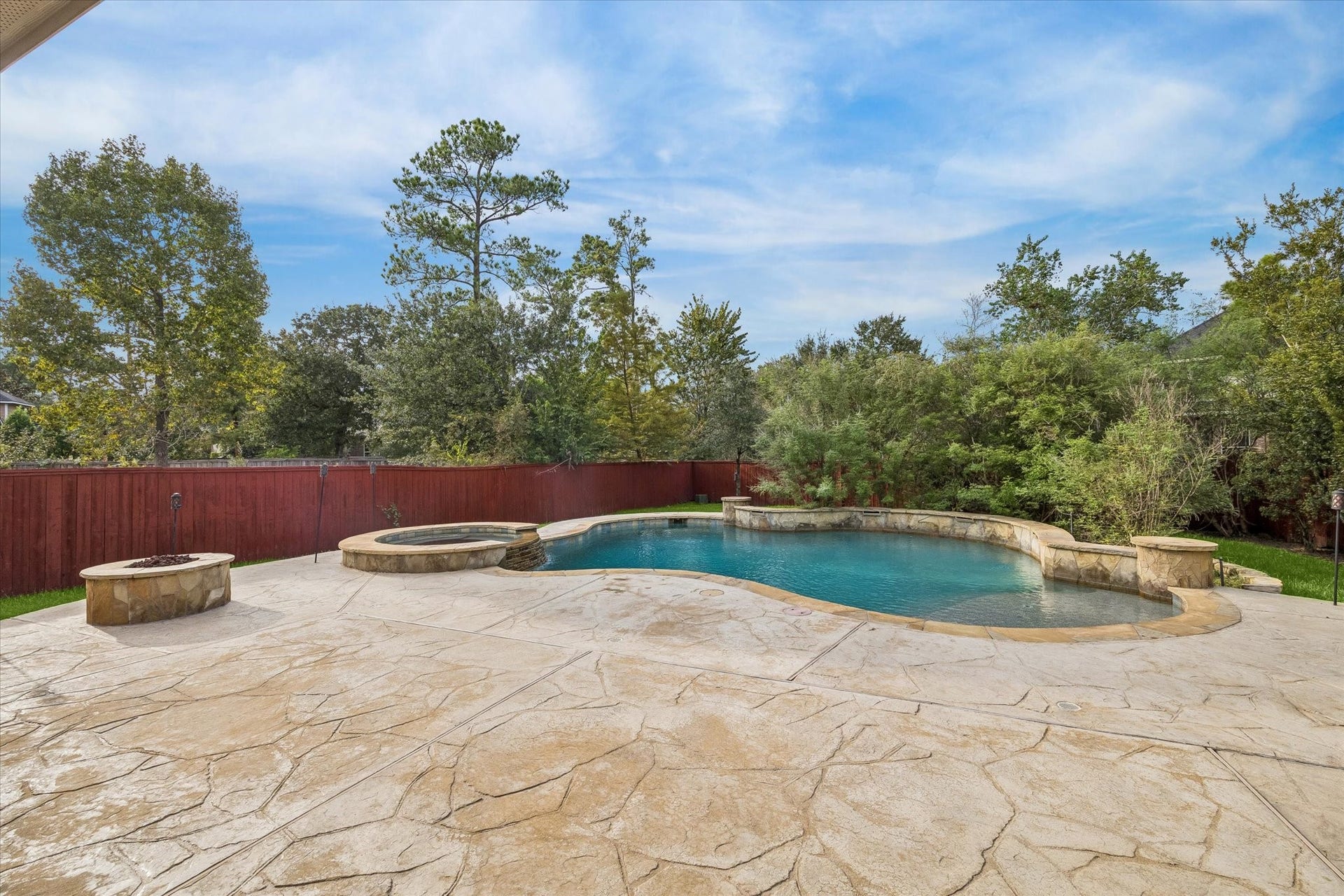 106 W Arbor Camp Circle, Spring, TX 77389 Gather around the firepit and enjoy the resort style pool. Notice how much privacy this lot offers