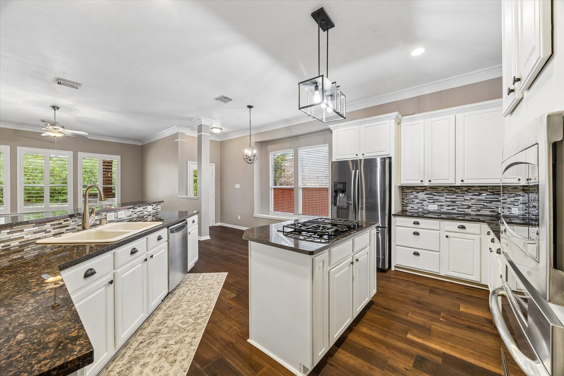 106 W Arbor Camp Circle, Spring, TX 77389 Modern kitchen opens up to living room and view of the pool. Notice the updated lighting fixture
