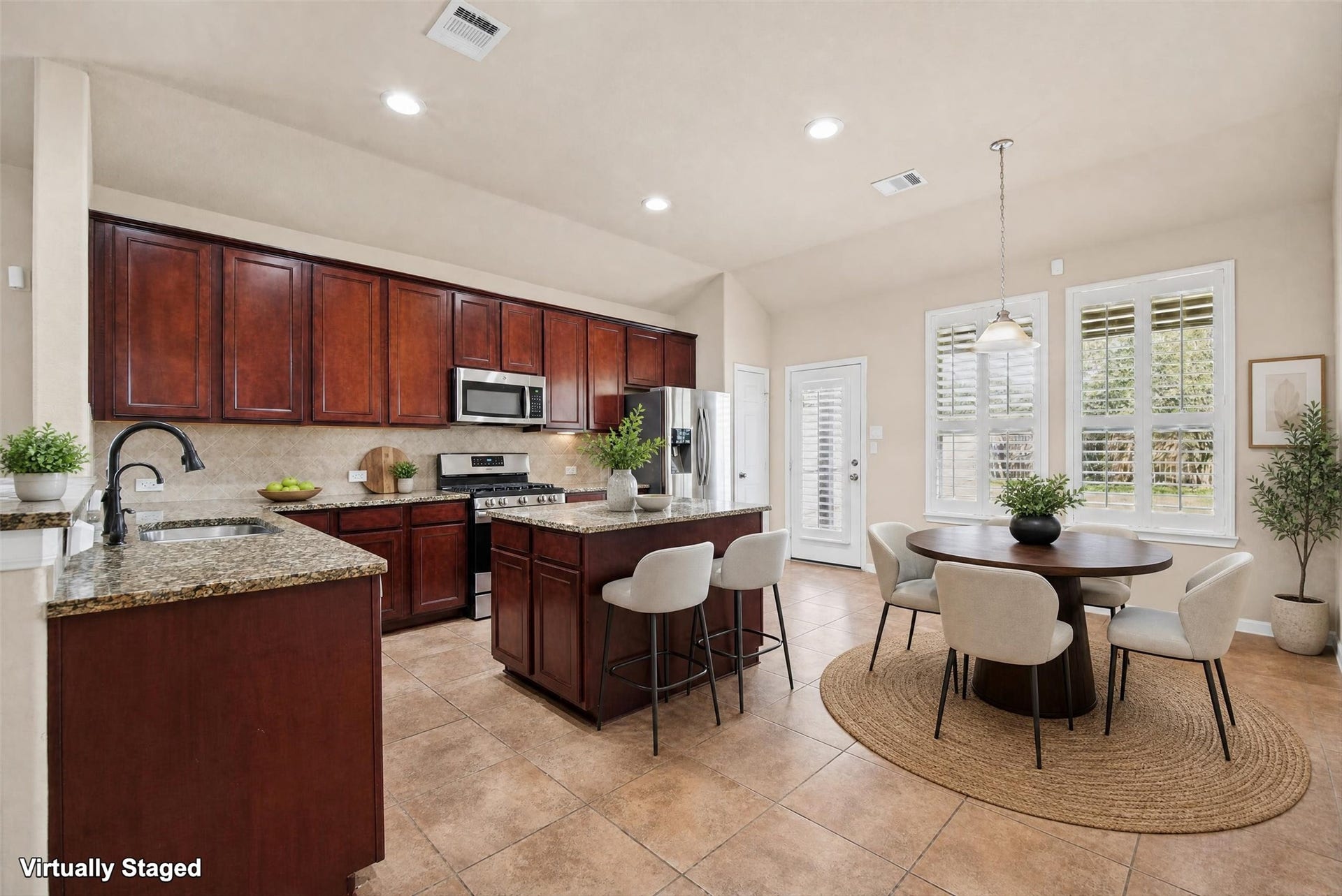 Virtually staged kitchen.  Notice the beautiful plantation shutters!
