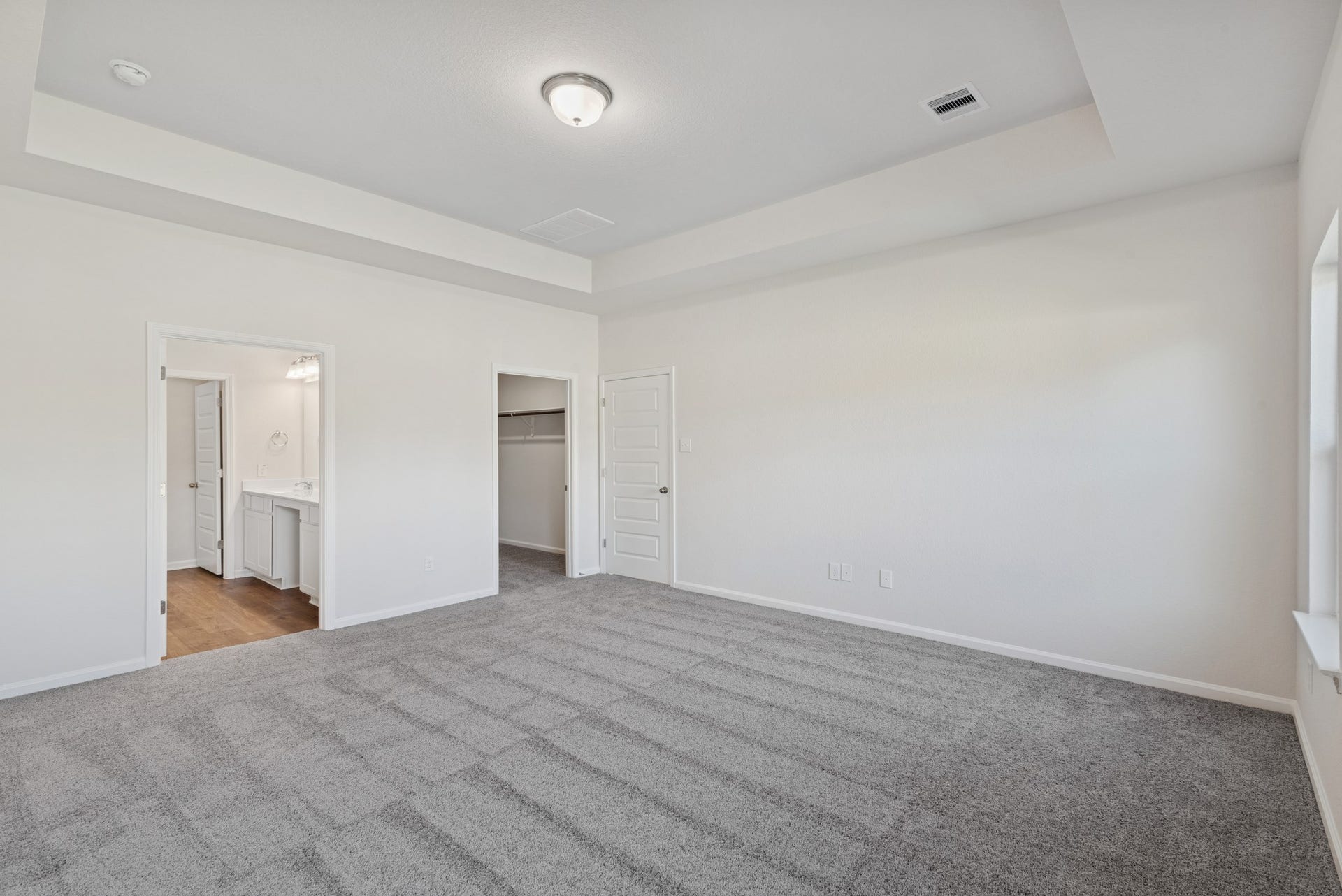 The Crawford- Primary Suite, Tray Ceiling not included. Home under construction, sample photo used for illustrative purposes only, colors and options will vary.