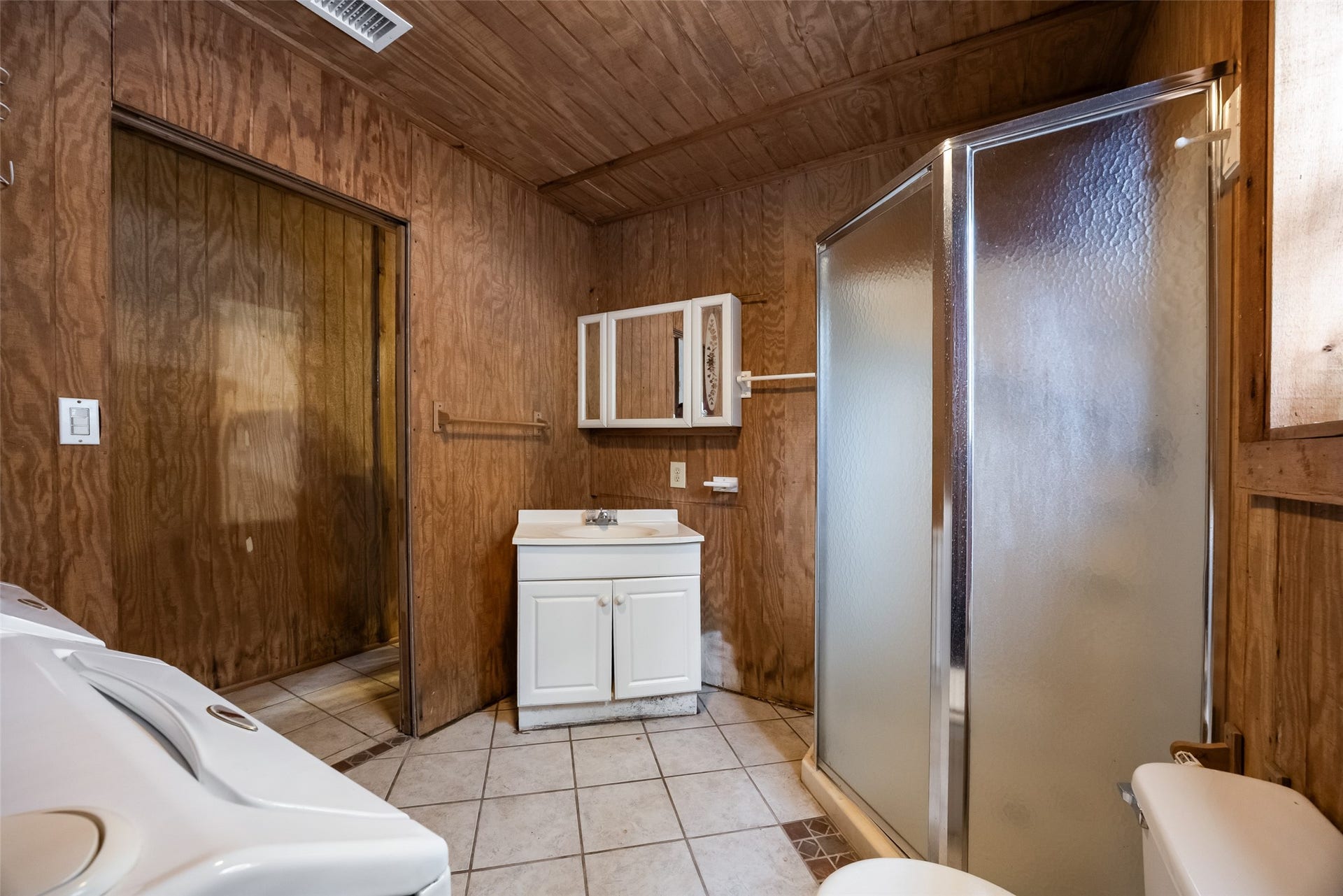27874 Riley Road, Waller, TX 77484 The barn's tack room also offers a pre-plumbed bathroom and utility area with a walk-in shower, vanity, toilet and space for laundry appliances. Water service is currently turned off, and plumbing repairs may be needed.