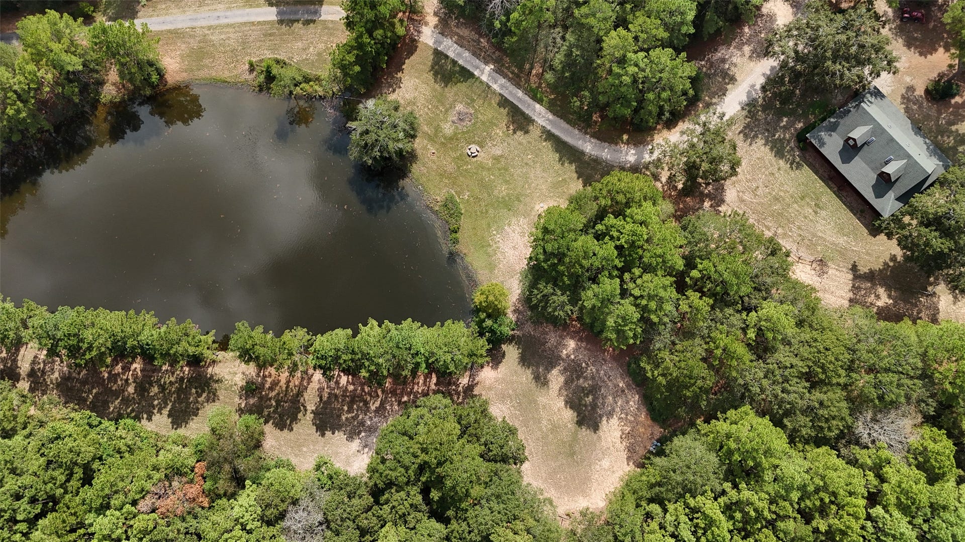 27874 Riley Road, Waller, TX 77484 Take a look from above! With 18+ acres to call your own, a charming 2-bedroom, 2.5-bath log cabin, a spacious barn with workshop, tack room, kitchen and full bathroom, plus a beautiful pond surrounded by trees, there's so much to love about this country retreat!