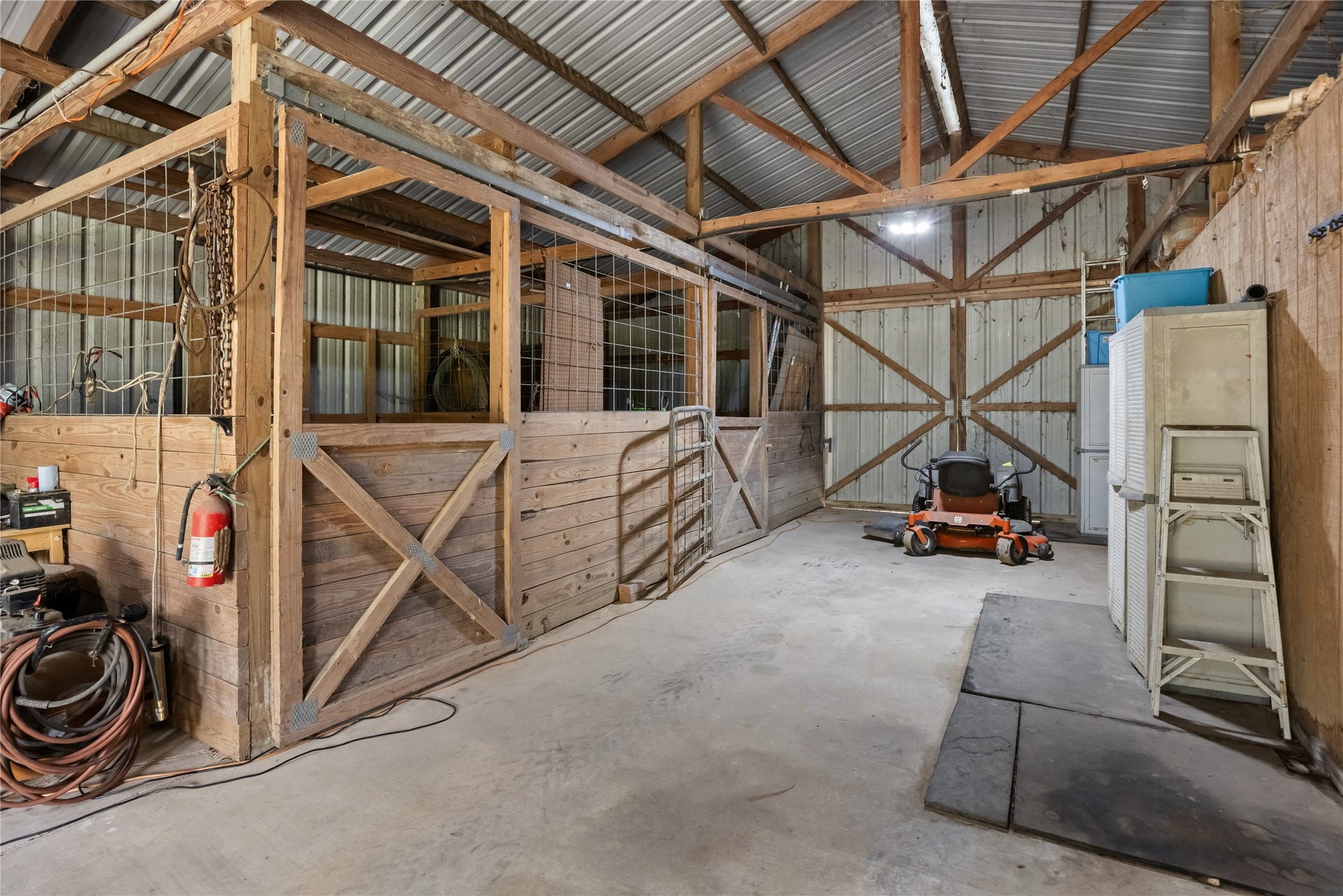 27874 Riley Road, Waller, TX 77484 This spacious barn offers plenty of room for equipment, tools and projects, with a concrete floor, metal roof, exposed wood framing and overhead lighting. Whether you need a workshop, storage or space for your hobbies, the possibilities are plentiful.