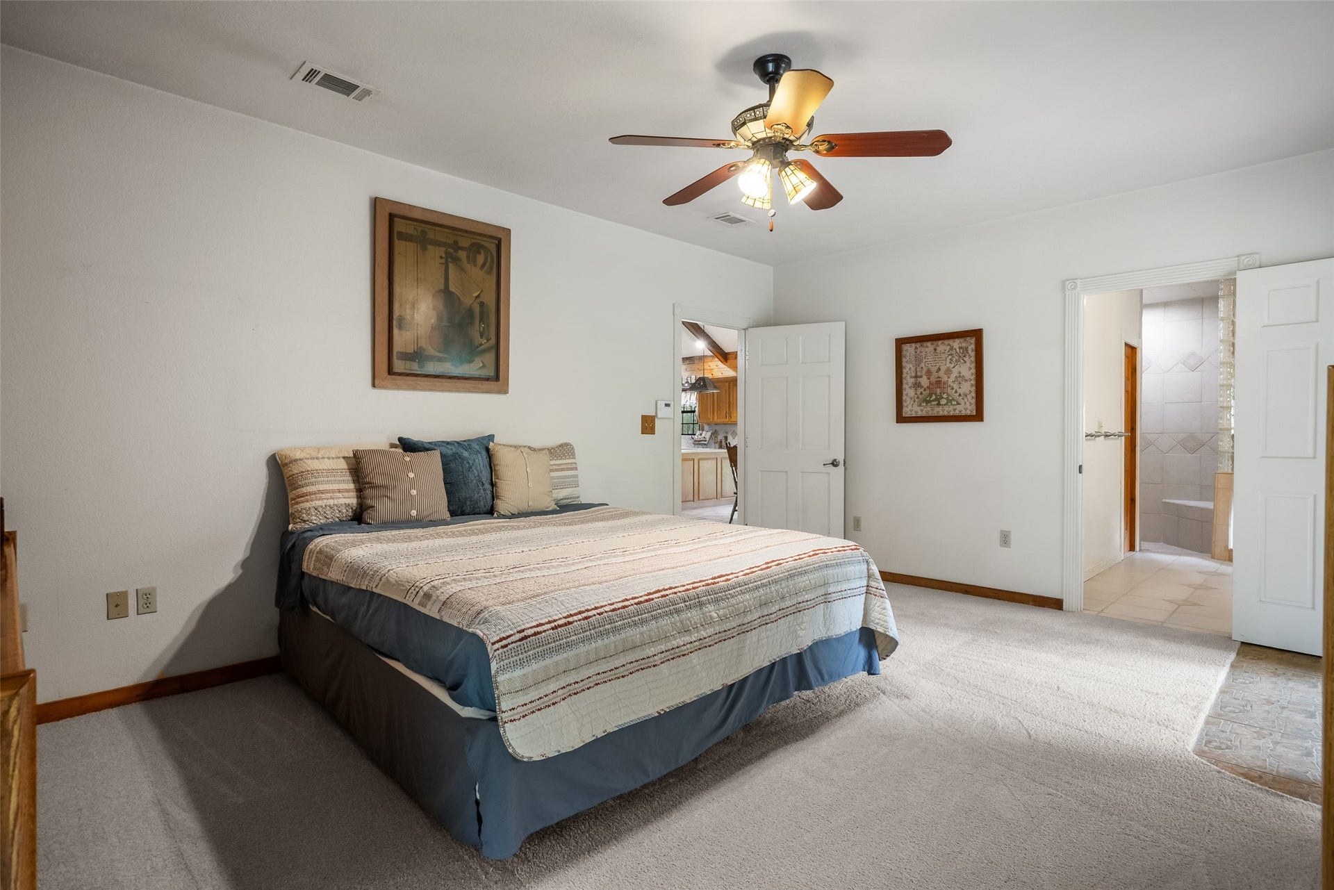 27874 Riley Road, Waller, TX 77484 There's plenty of room to relax and unwind in this inviting primary suite, where a neutral color palette, soft carpet and private ensuite bathroom make it easy to settle in and feel right at home.