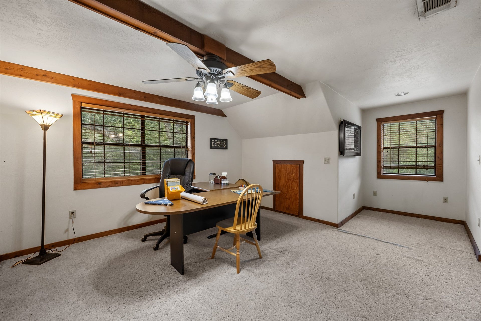 27874 Riley Road, Waller, TX 77484 This spacious upstairs loft offers plenty of flexibility for a home office, study, game room or second living area. Exposed wood beams, a ceiling fan and large windows overlooking the property add to its charm. With the addition of a wall, this space could easily become a third bedroom.