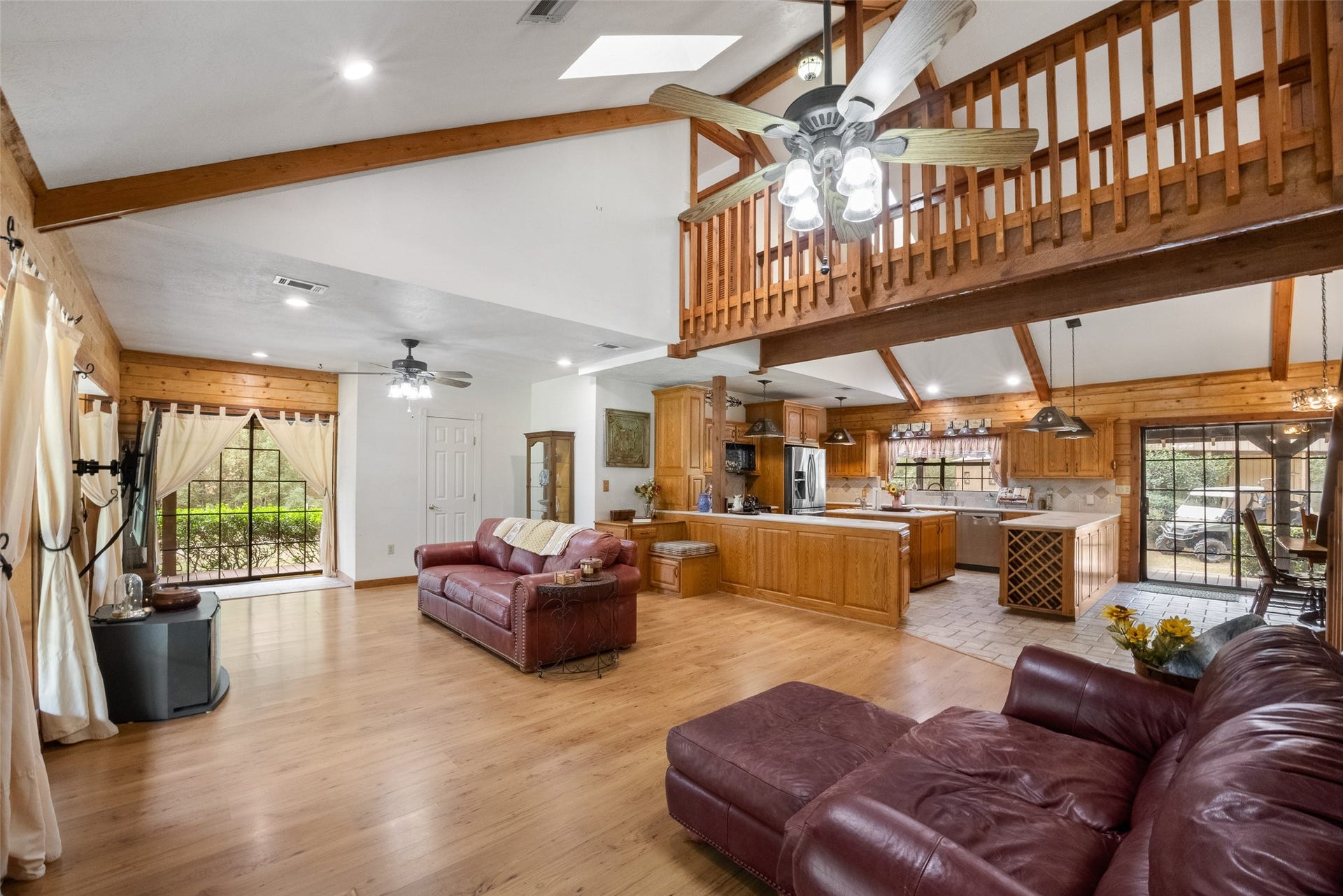 27874 Riley Road, Waller, TX 77484 There's plenty of room to relax and entertain in this open living area, where soaring ceilings, exposed wood beams and an upstairs loft add character. The easy flow into the kitchen and dining area keeps everyone connected, whether you're hosting friends or enjoying a quiet evening at home.