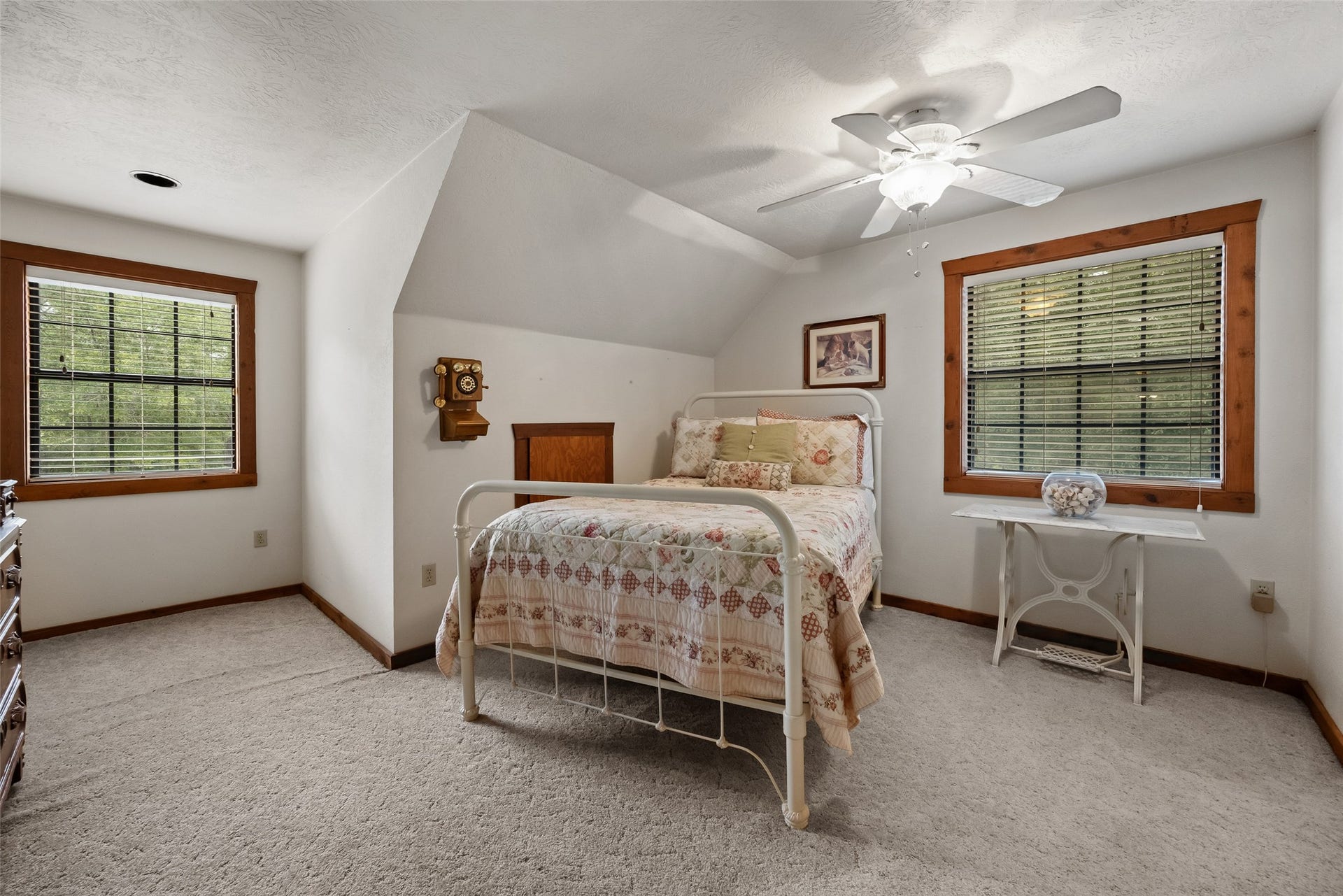 27874 Riley Road, Waller, TX 77484 Your guests will feel right at home in this charming upstairs bedroom with warm wood trim and windows that offer peaceful views of the surrounding trees. This bedroom is complete with a full ensuite bathroom and a walk-in closet.