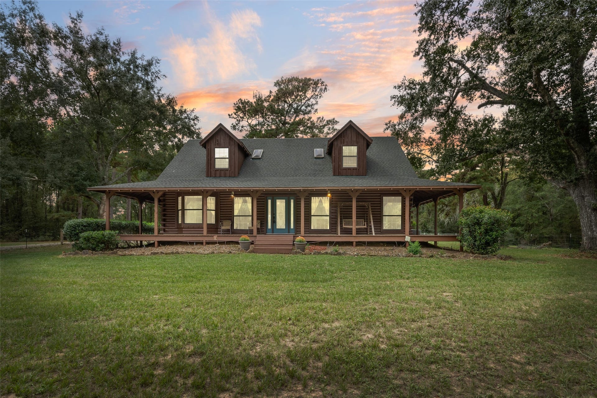 27874 Riley Road, Waller, TX 77484 Welcome to your own little slice of country paradise! Nestled among beautiful mature trees on 18+ private acres, this charming 2-bedroom, 2 1/2 bath log cabin offers soaring vaulted ceilings with exposed wood beams, rustic wood finishes, a spacious loft/game room and an inviting wraparound porch. A private pond and metal barn with 2 stalls, workshop, tack room, kitchen and full bath add endless possibilities. Come enjoy the peace, privacy and wide-open spaces of country living!