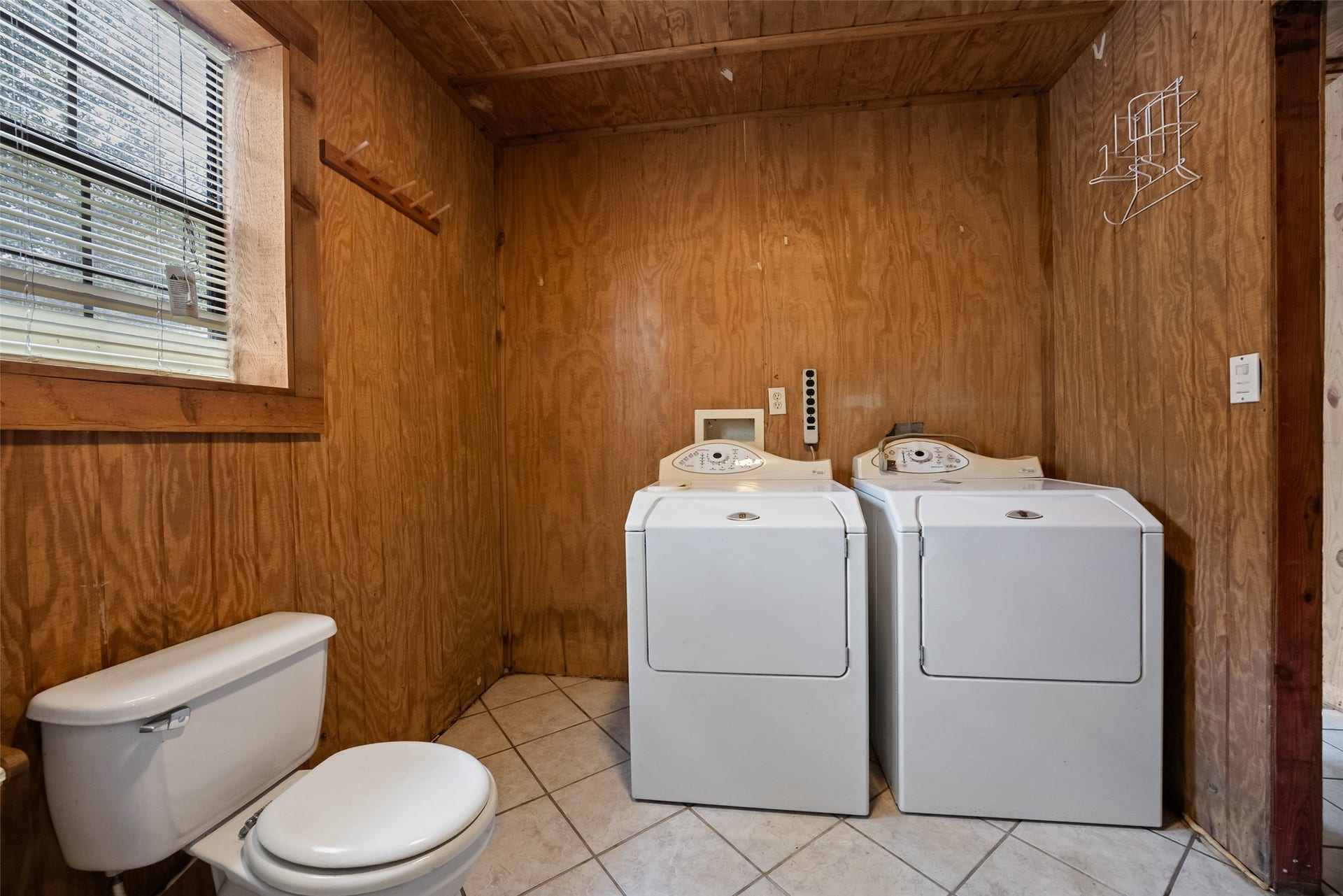 27874 Riley Road, Waller, TX 77484 A dedicated laundry area within the bathroom provides space for a washer and dryer, with tile flooring and a window for natural light.