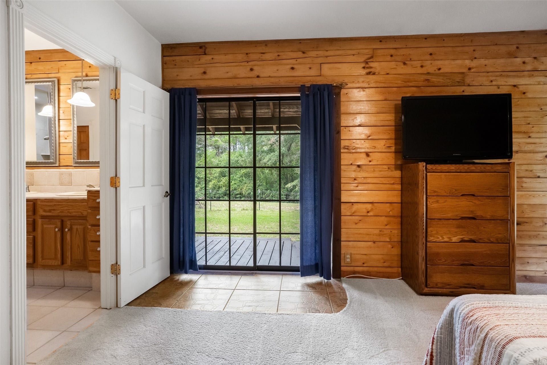 27874 Riley Road, Waller, TX 77484 Wake up to beautiful country views and step right outside onto the wraparound porch for a little fresh air! Direct access to the private bathroom adds everyday convenience to this charming primary retreat.