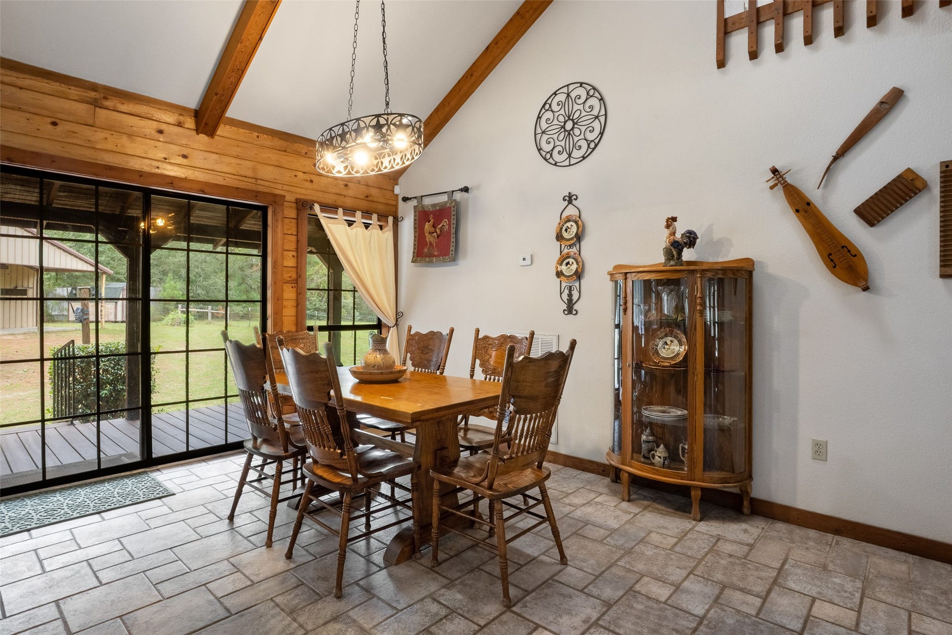 27874 Riley Road, Waller, TX 77484 Gather around the table and enjoy a meal with peaceful country views! This charming dining area features a soaring ceiling with exposed wood beams, tile flooring and easy access to the wraparound porch.