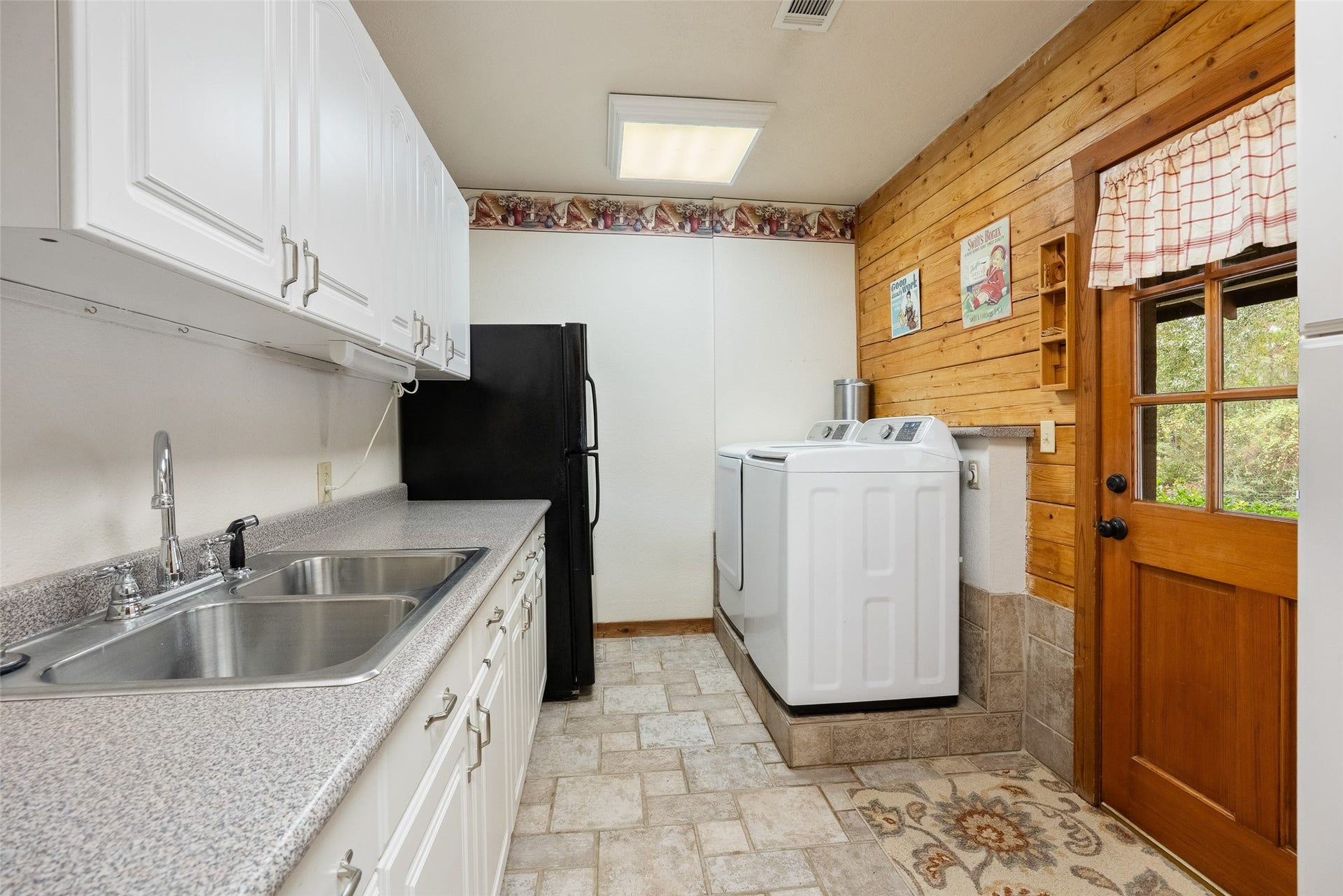 27874 Riley Road, Waller, TX 77484 This spacious utility room is ready to tackle laundry day with room to spare! A long countertop, abundant cabinetry, double sink and space for an extra refrigerator make everyday chores and household organization a whole lot easier.