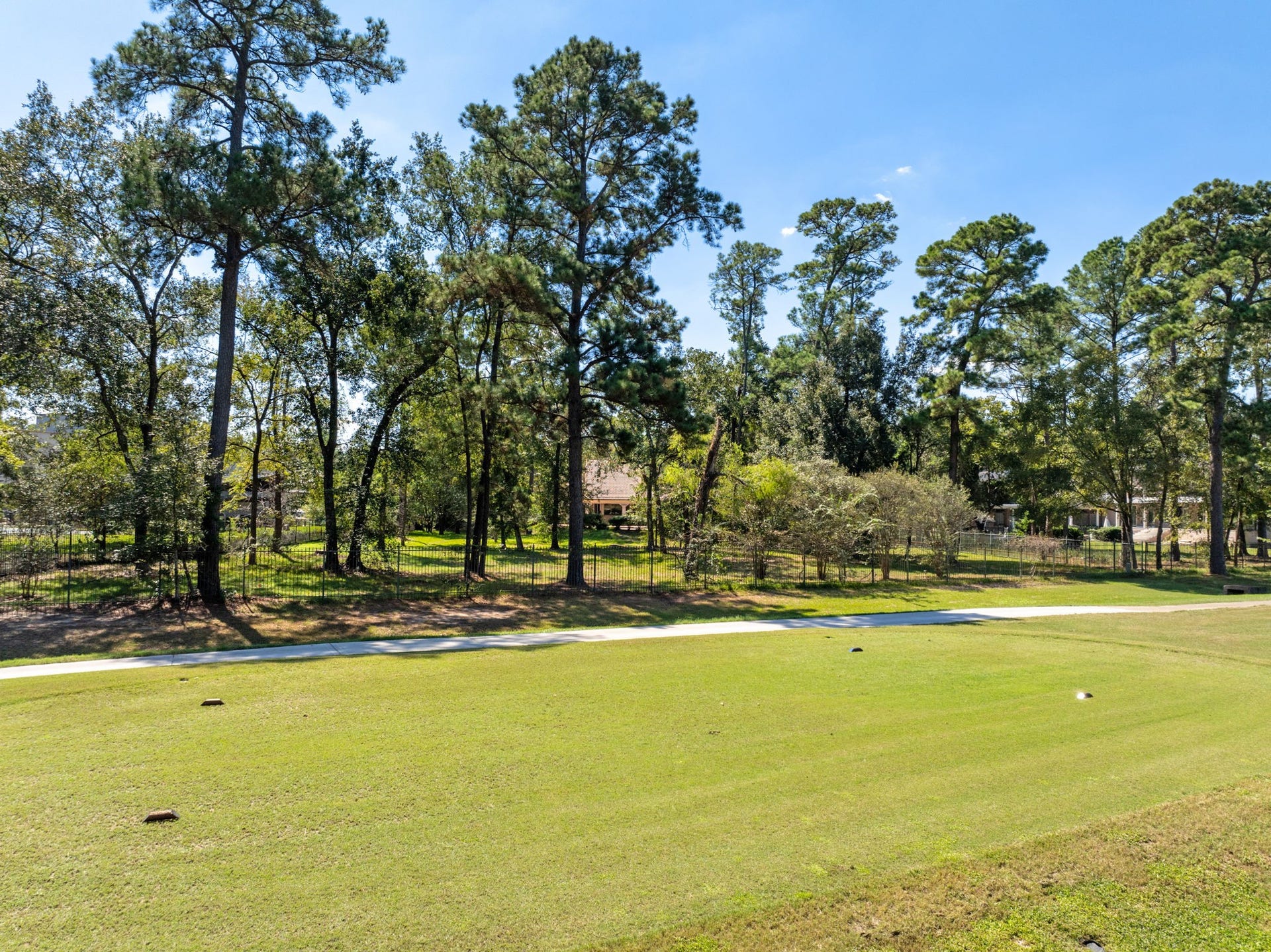 43 N Longspur Drive, The Woodlands, TX 77380 View from golf course to the backyard of this 1.4 acre lot.