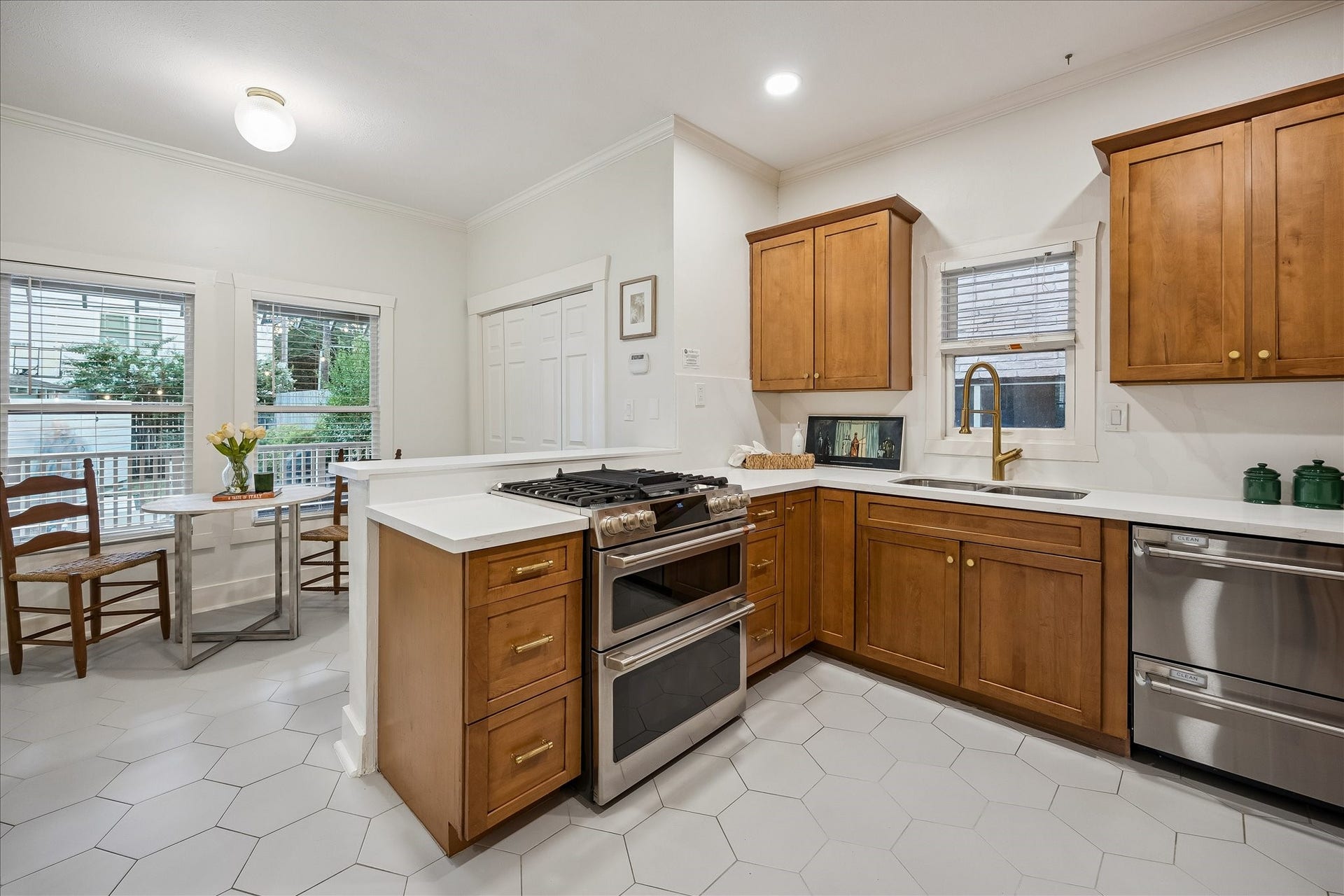 1635 Harvard Street, Houston, TX 77008 Kitchen and breakfast area with updated tile floors and GE Caf appliances (range, oven, and dishwasher) installed in 2023.