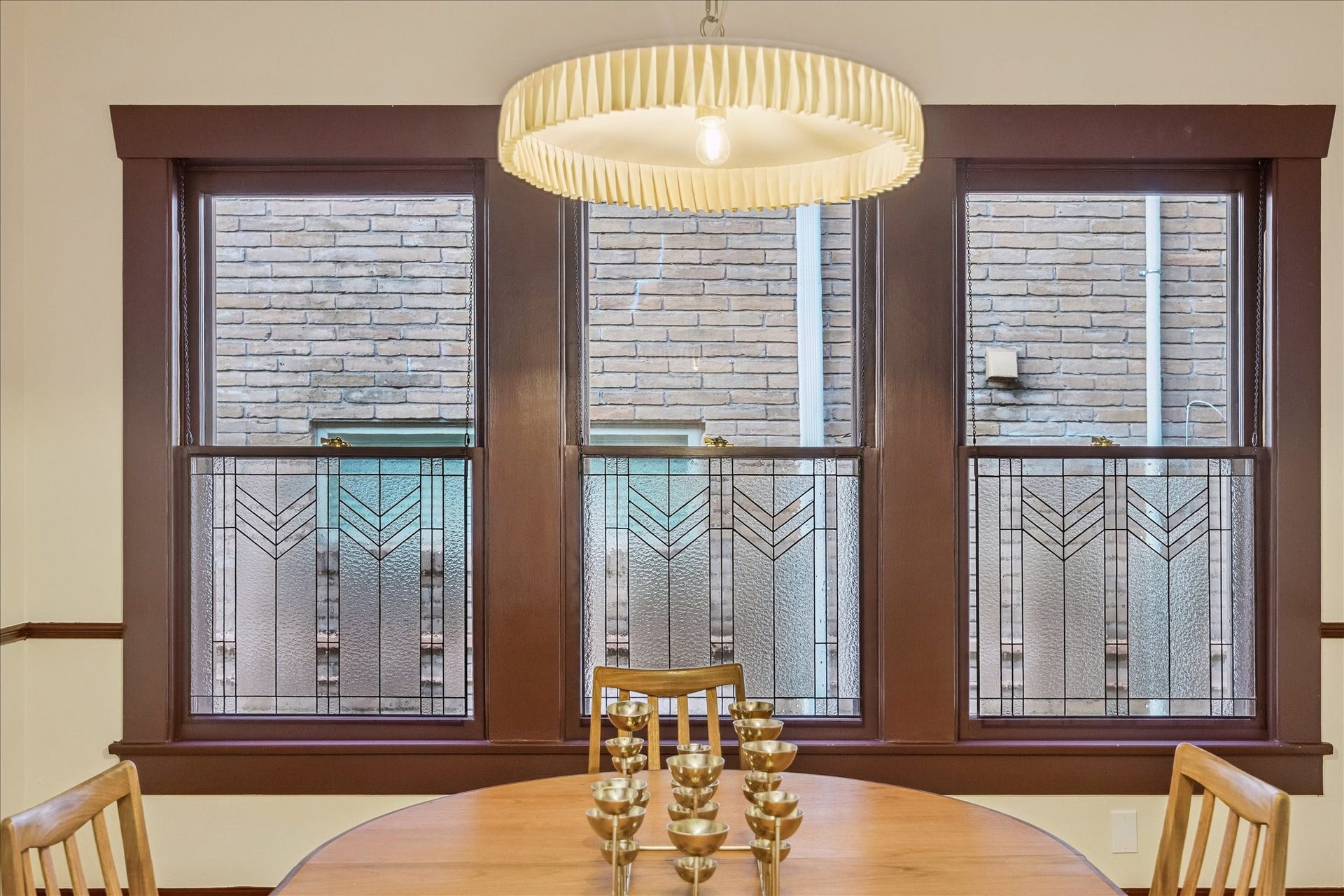 1635 Harvard Street, Houston, TX 77008 The formal dining room features wood stained trim & chair rail, as well as custom stained glass windows & updated lighting.