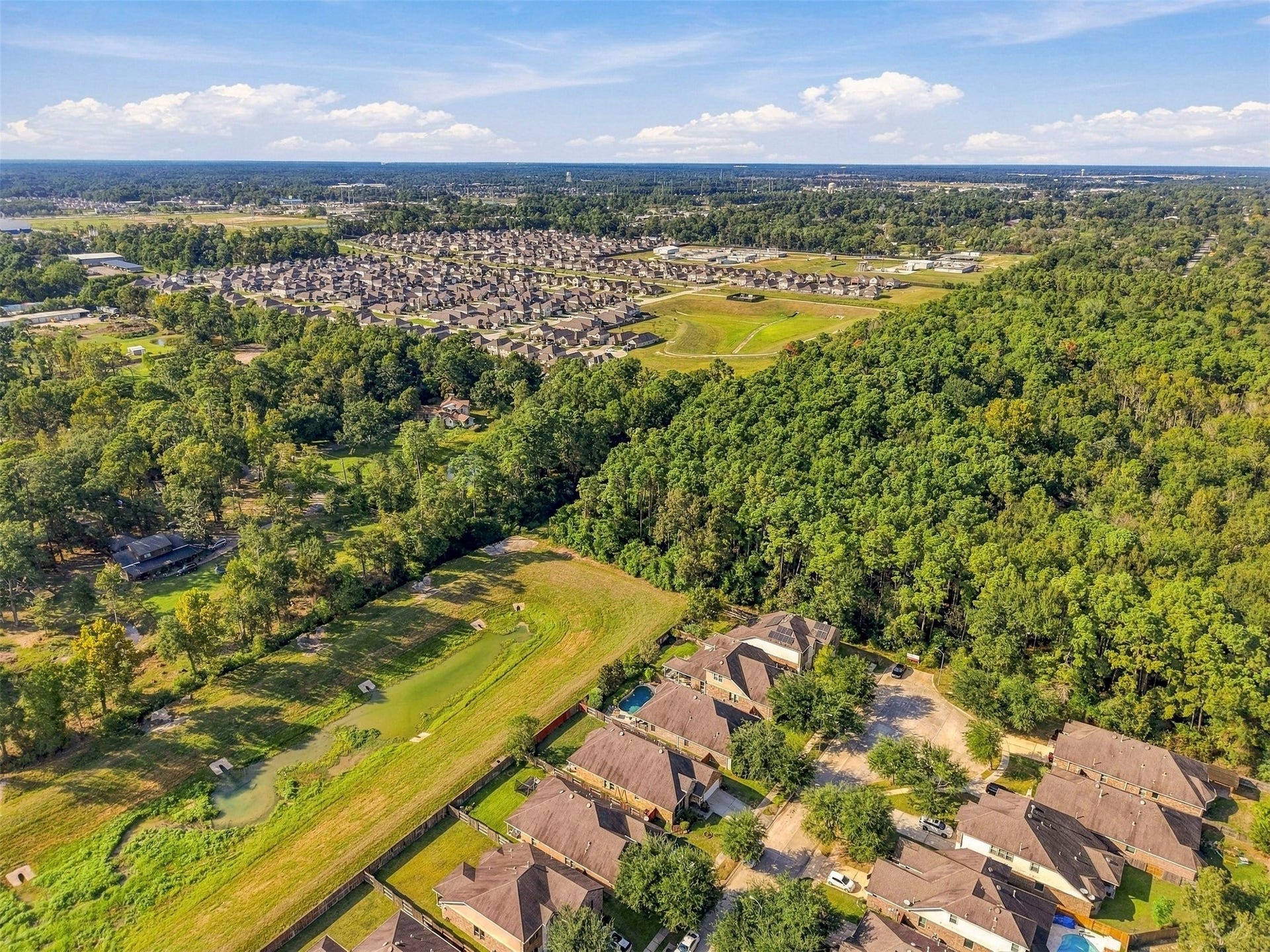 4557 Argonne Woods Drive, Porter, TX 77365 Nestled amidst lush greenery, this neighborhood offers a serene, wooded backdrop with plenty of privacy, complemented by nearby amenities and a vibrant community setting.